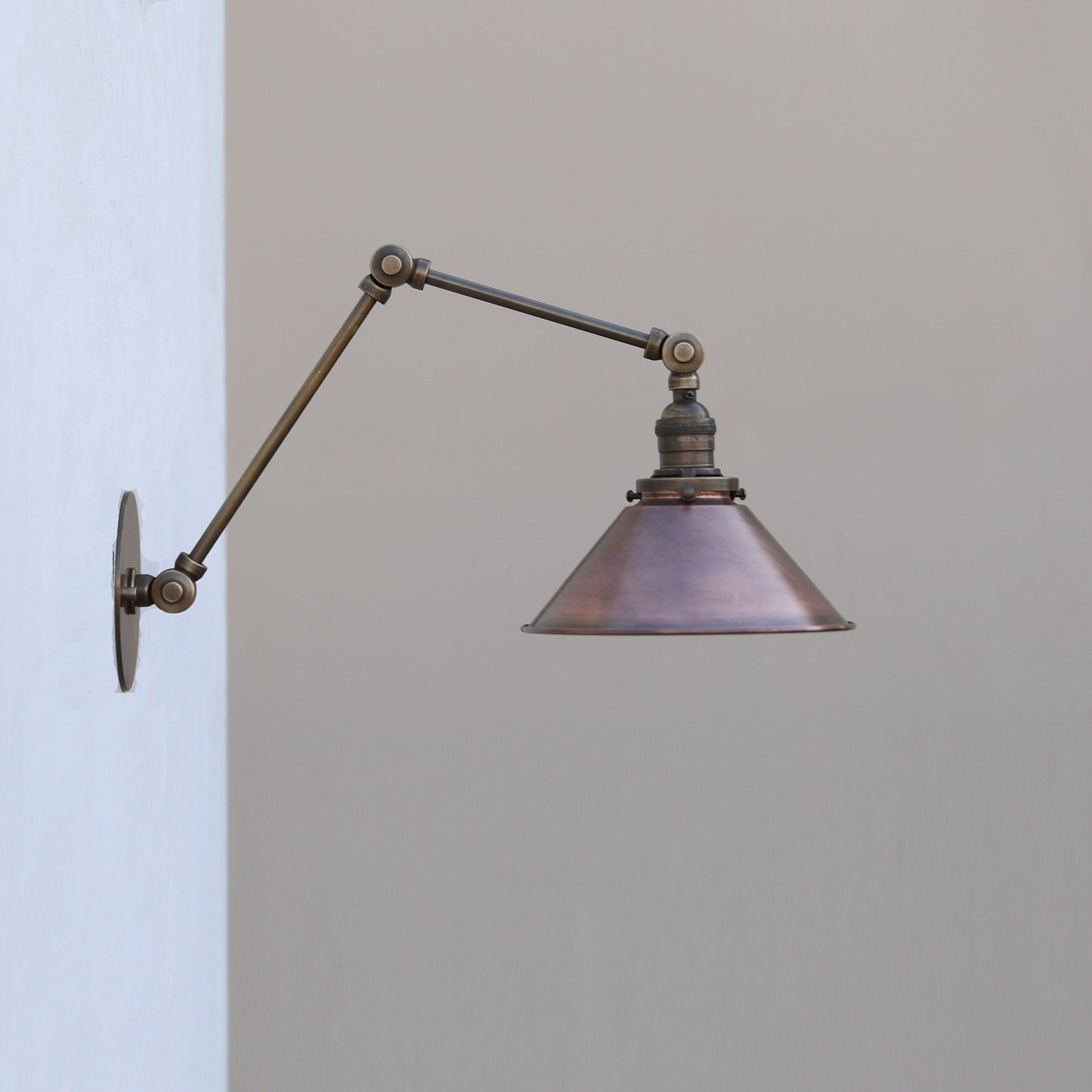 Adjustable Swing-Arm Wall Sconce with Aged Copper Cone Shade