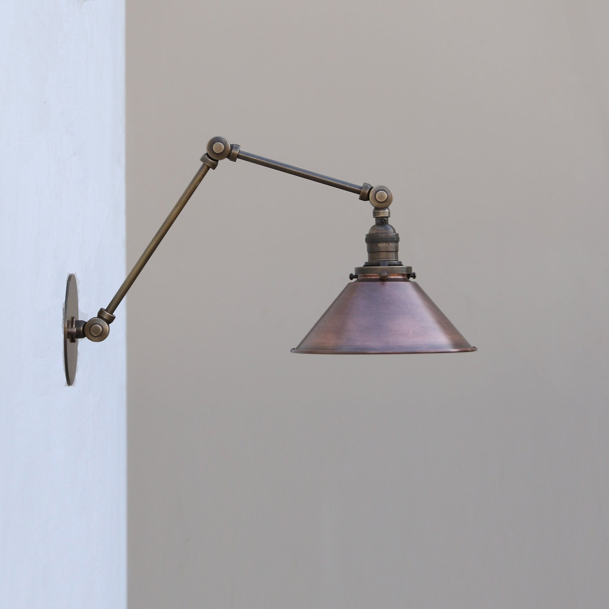 Adjustable Swing-Arm Wall Sconce with Aged Copper Cone Shade