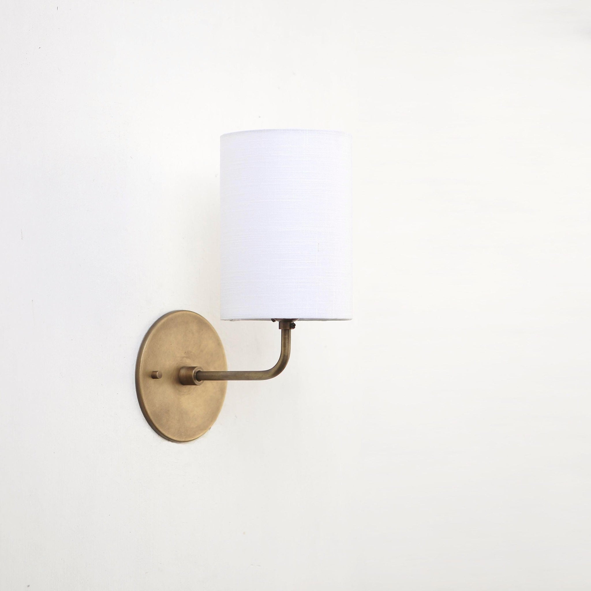 Curved Arm Brass Wall Sconce with Linen Drum Shade