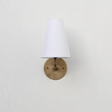 Curved Arm Brass Wall Sconce with Tapered Linen Shade