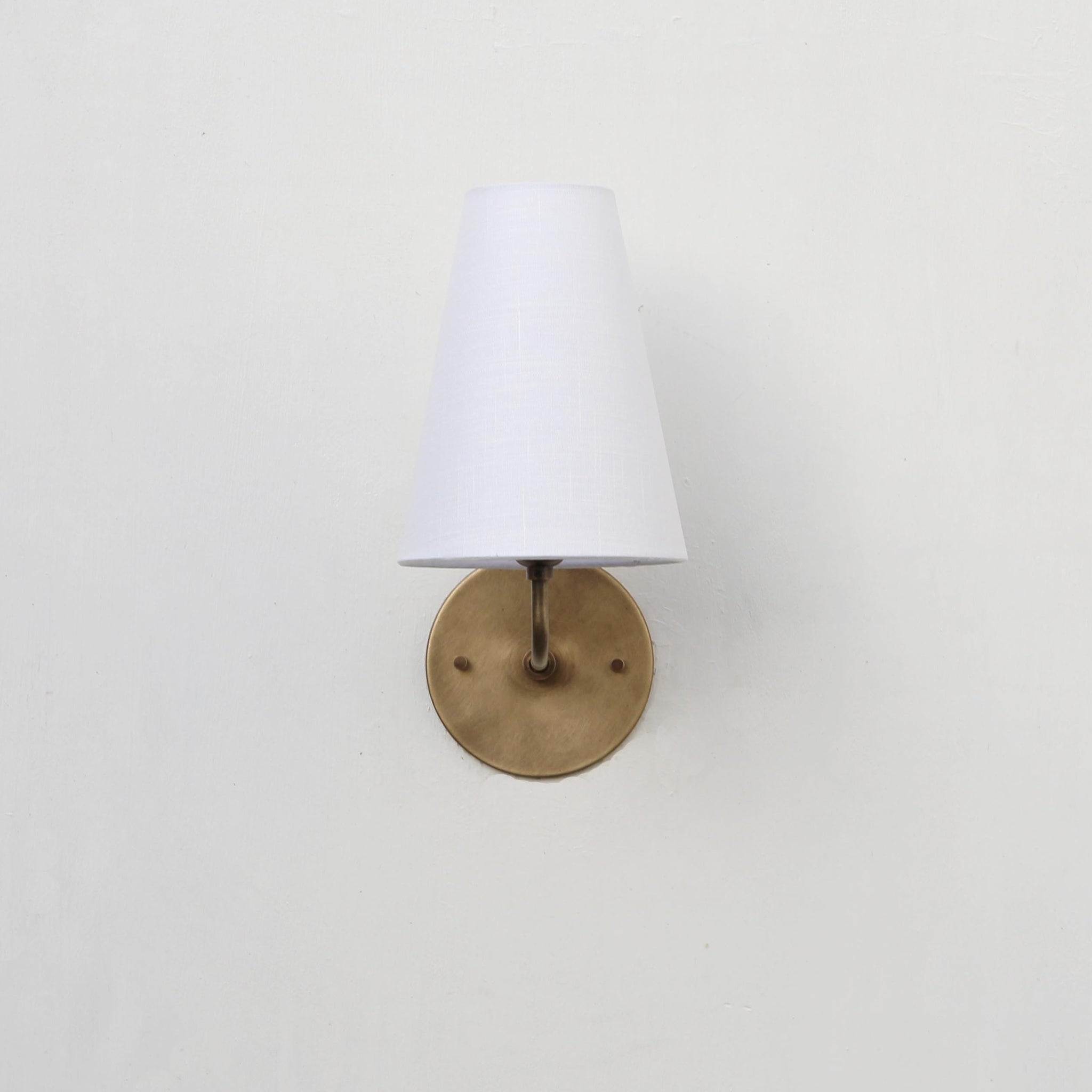 Curved Arm Brass Wall Sconce with Tapered Linen Shade