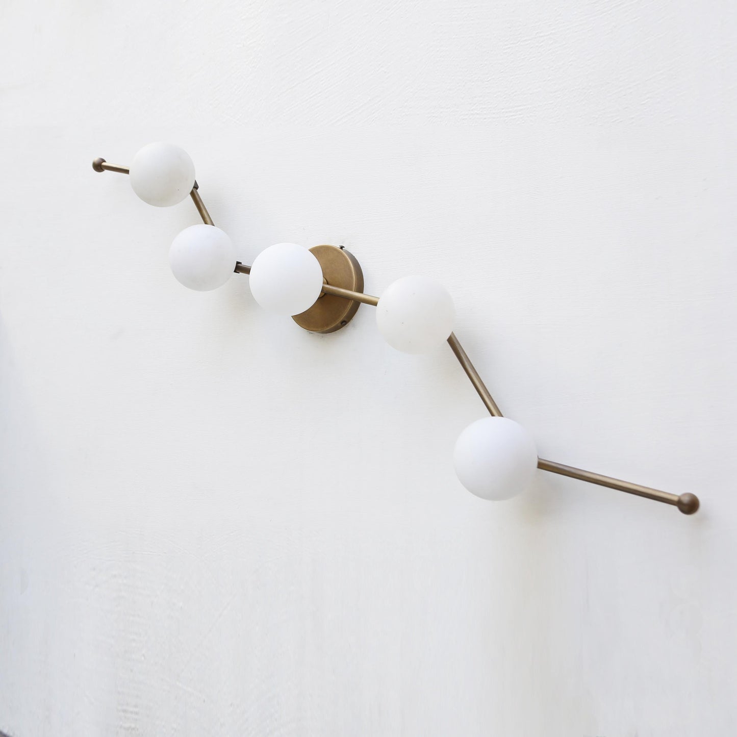 Five-Light Staggered Brass Bar Sconce with Opal Glass Globes