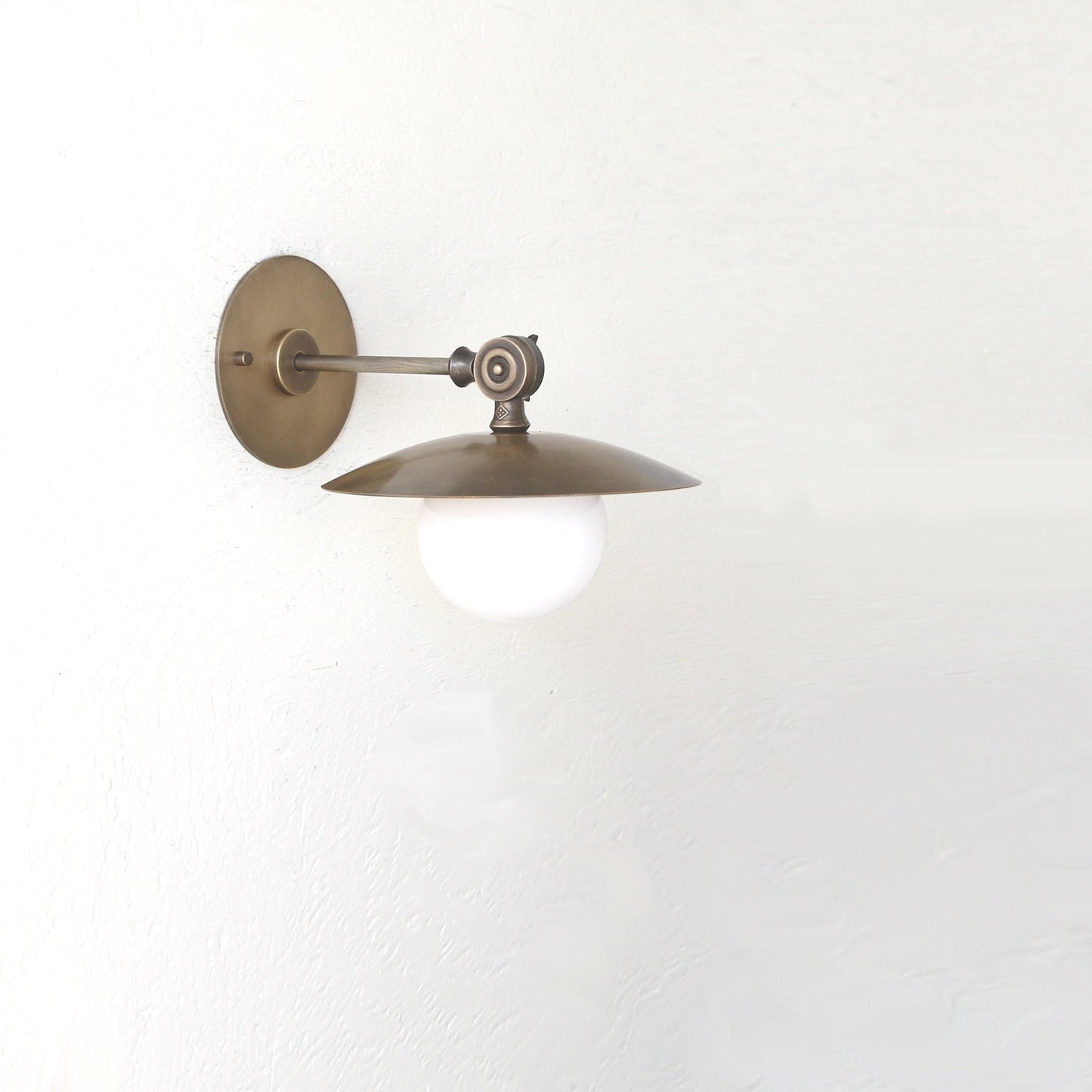 One-Light Adjustable Brass Saucer Wall Sconce with Opal Globe