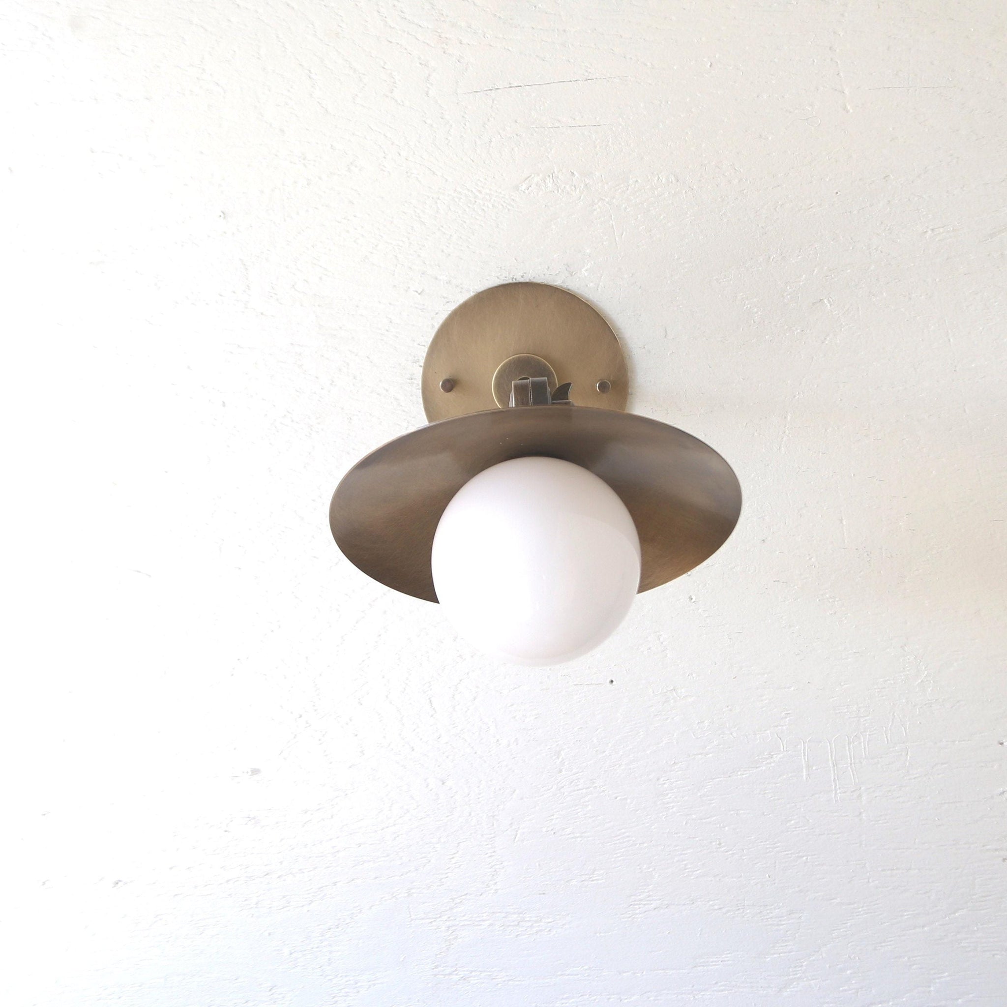 One-Light Adjustable Brass Saucer Wall Sconce with Opal Globe