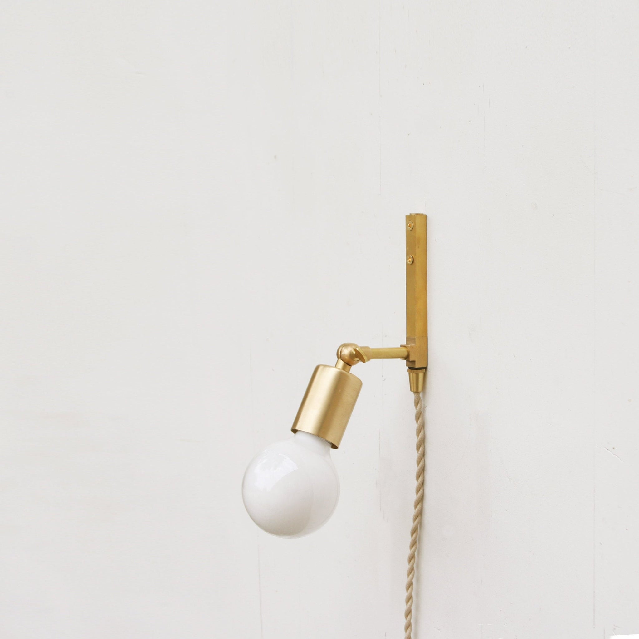 One-Light Adjustable Plug-In Wall Sconce with Exposed Bulb