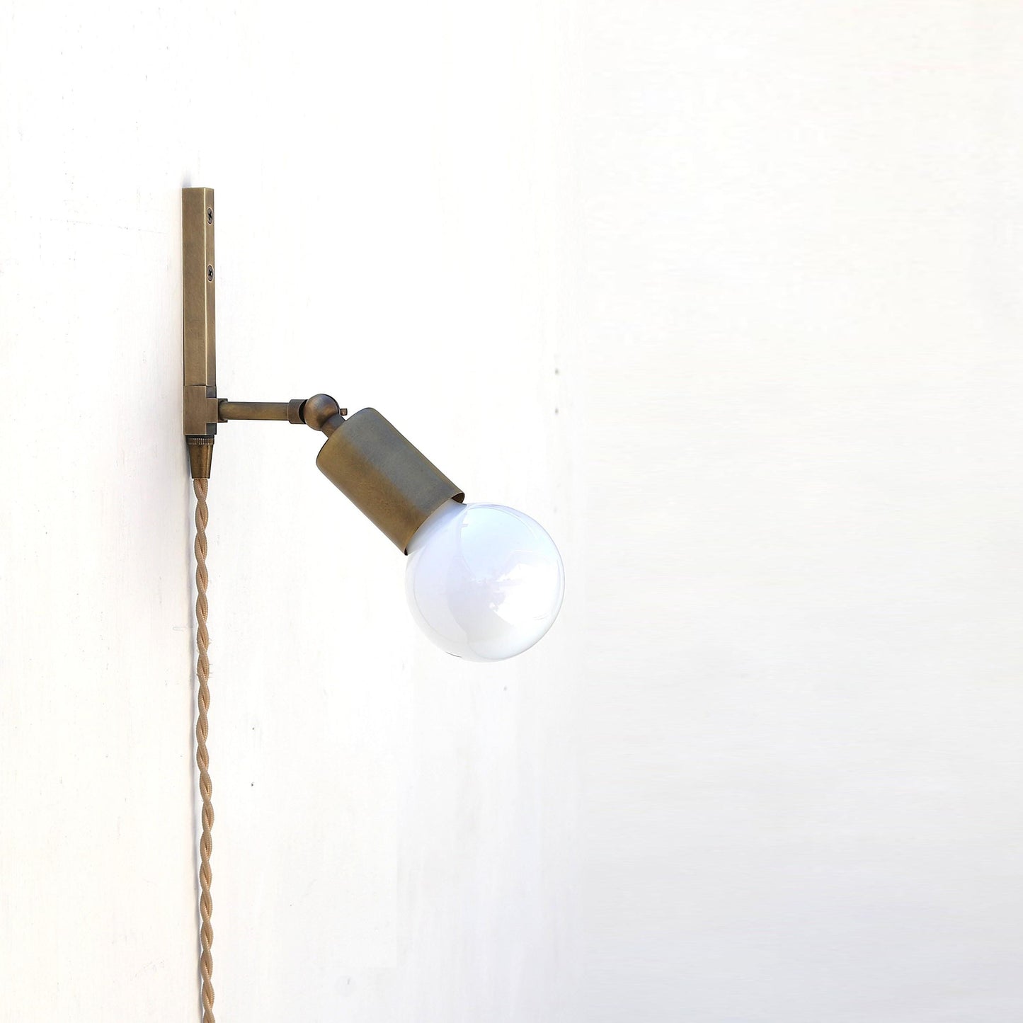One-Light Adjustable Plug-In Wall Sconce with Exposed Bulb