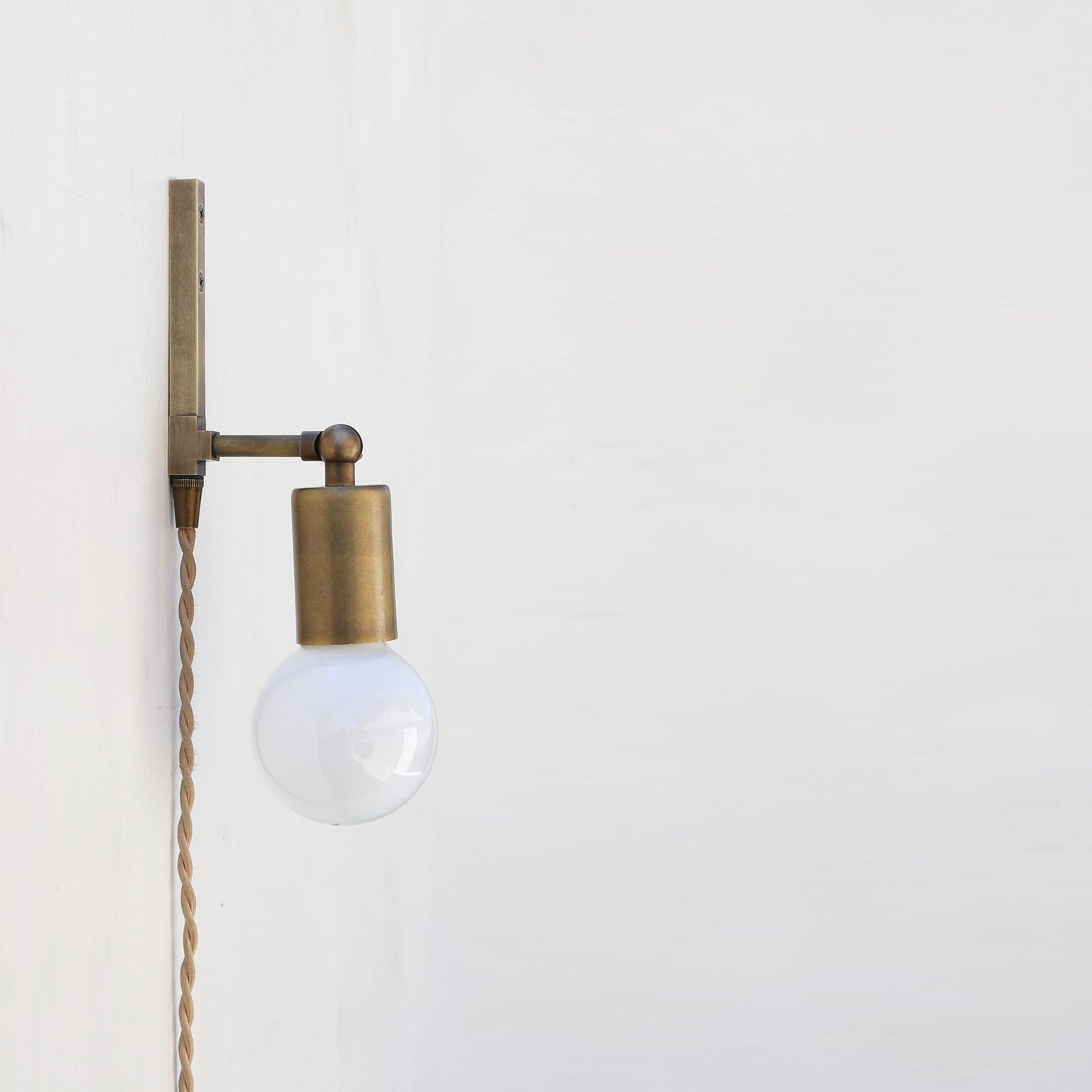 One-Light Adjustable Plug-In Wall Sconce with Exposed Bulb