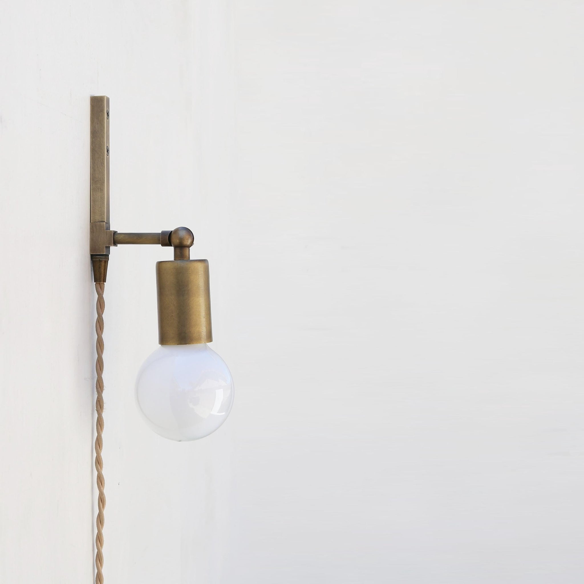 One-Light Adjustable Plug-In Wall Sconce with Exposed Bulb