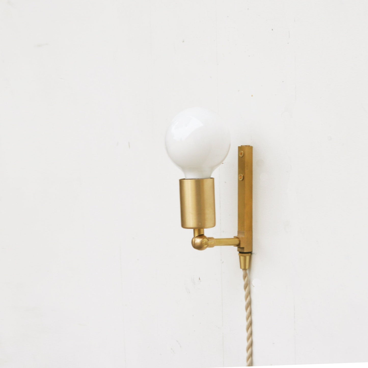 One-Light Adjustable Plug-In Wall Sconce with Exposed Bulb