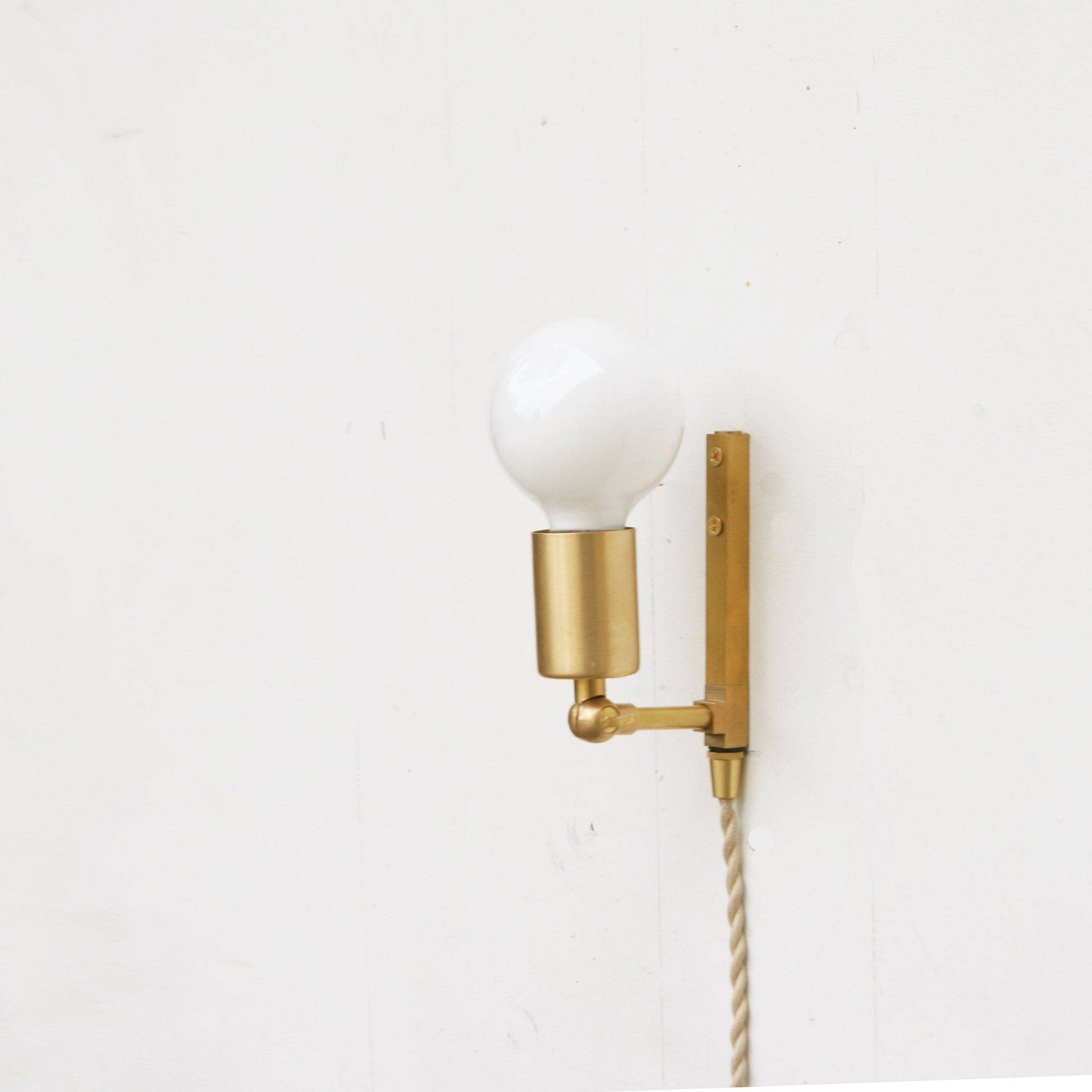 One-Light Adjustable Plug-In Wall Sconce with Exposed Bulb