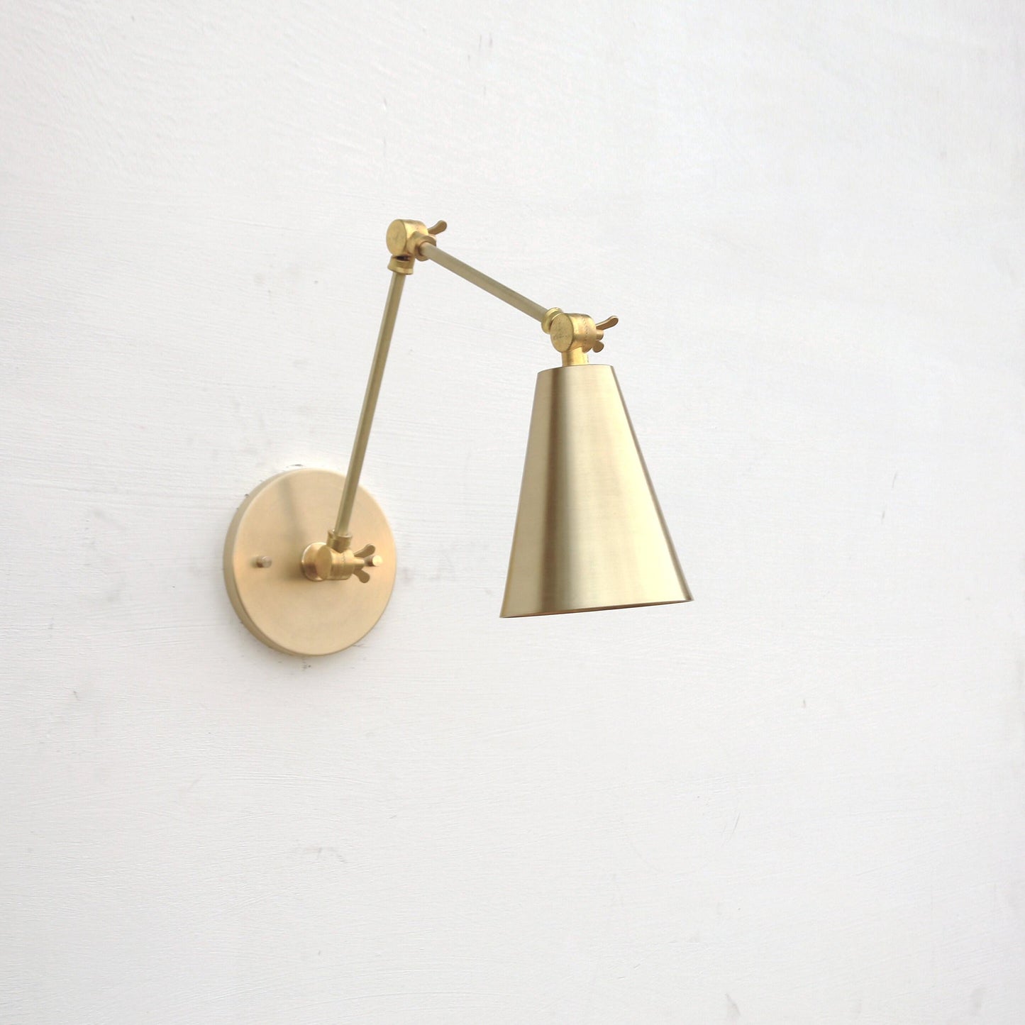 One-Light Adjustable Swing Arm Wall Sconce with Large Brass Cone