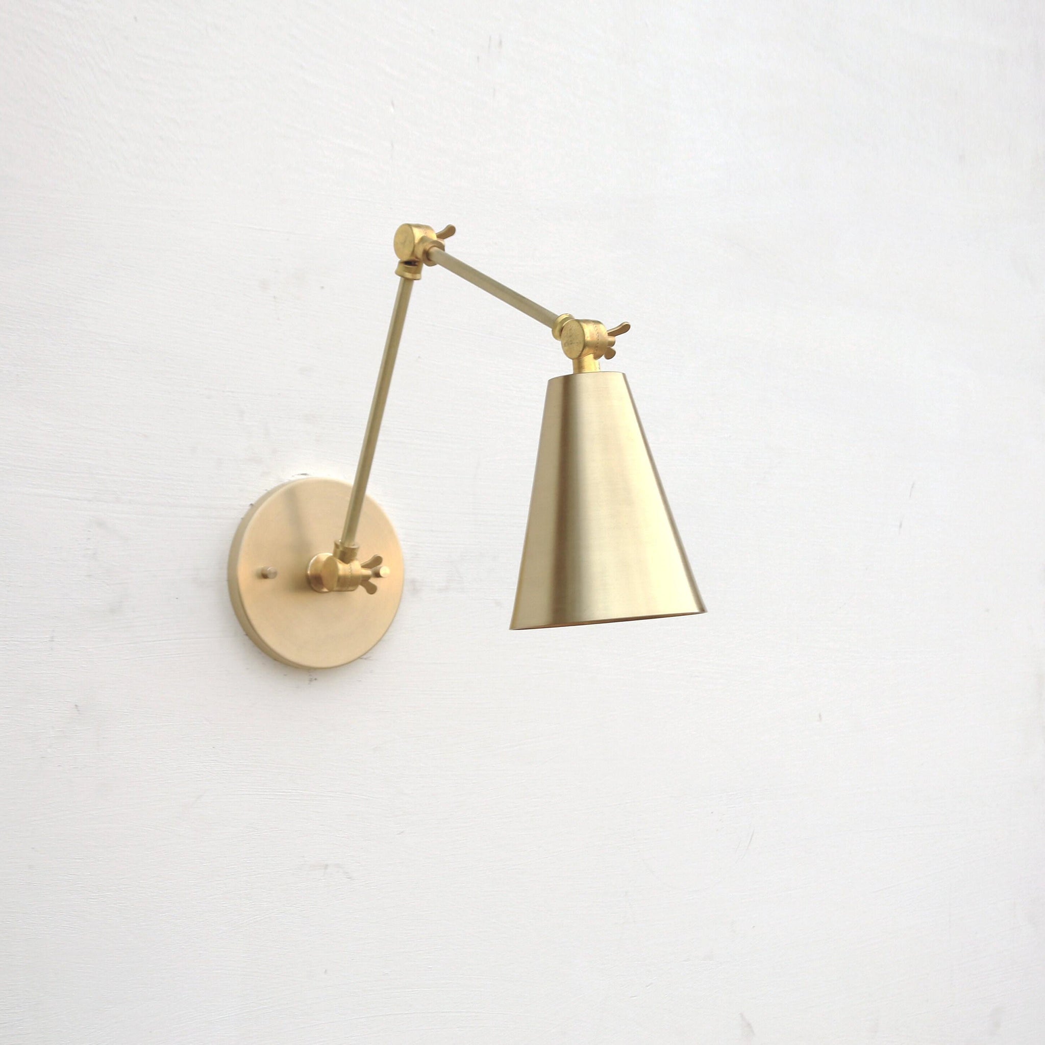 One-Light Adjustable Swing Arm Wall Sconce with Large Brass Cone