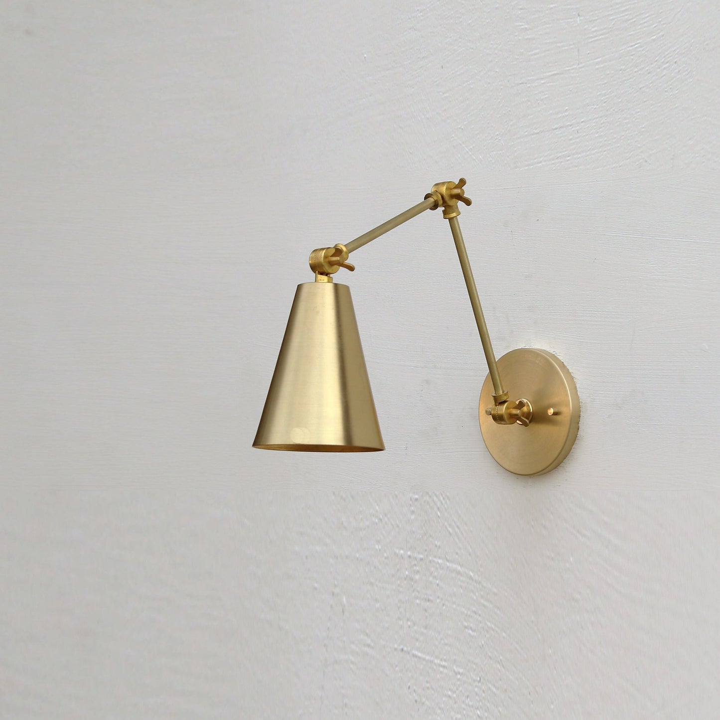 One-Light Adjustable Swing Arm Wall Sconce with Large Brass Cone