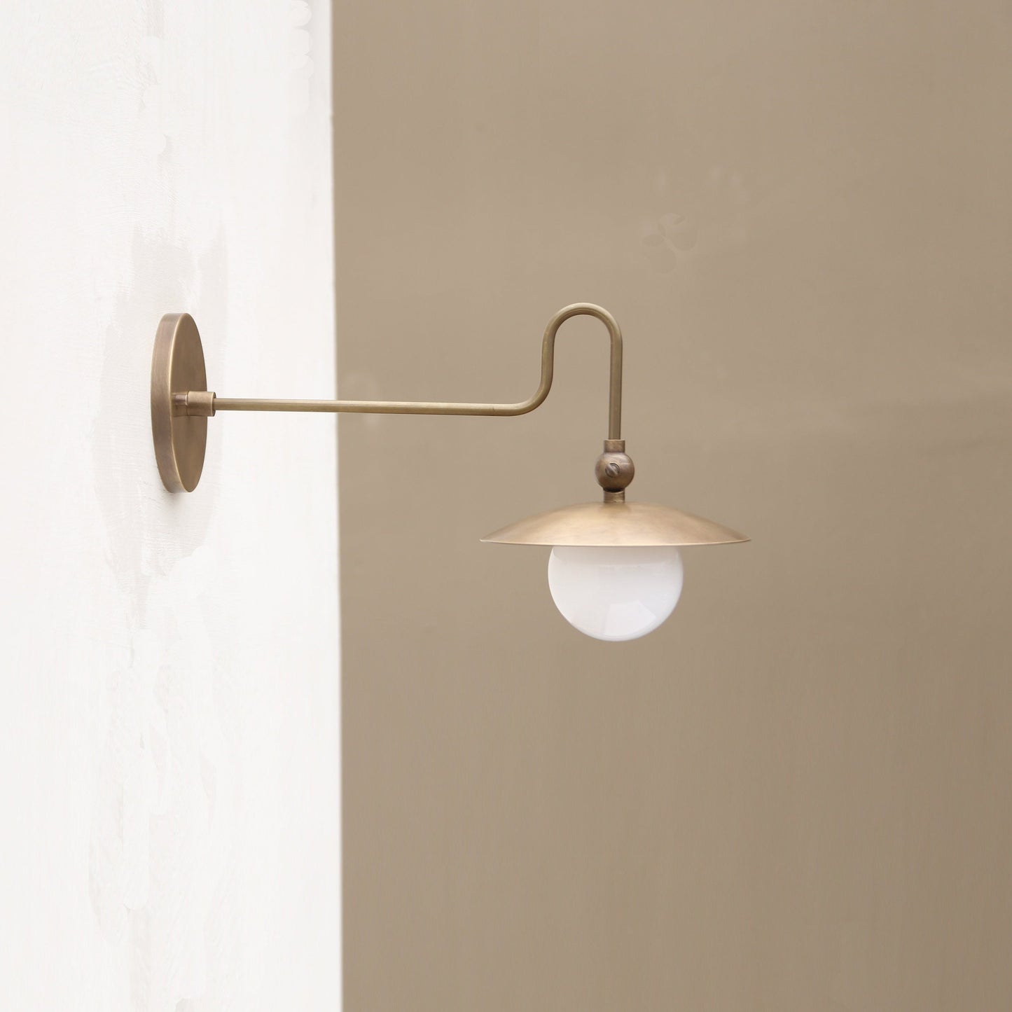 One-Light Brass Dish Wall Sconce with Curved Arm and Milk Glass Shade