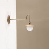One-Light Brass Dish Wall Sconce with Curved Arm and Milk Glass Shade