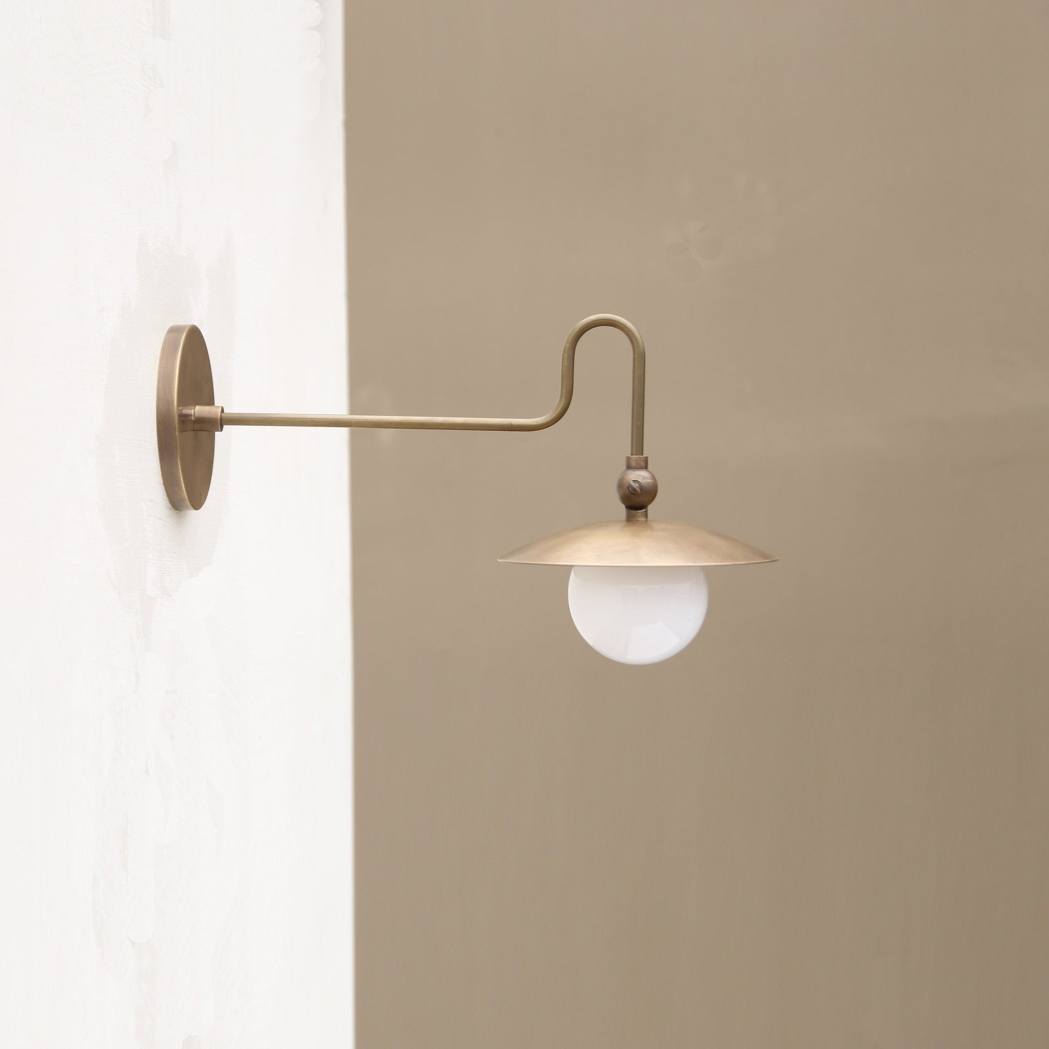 One-Light Brass Dish Wall Sconce with Curved Arm and Milk Glass Shade