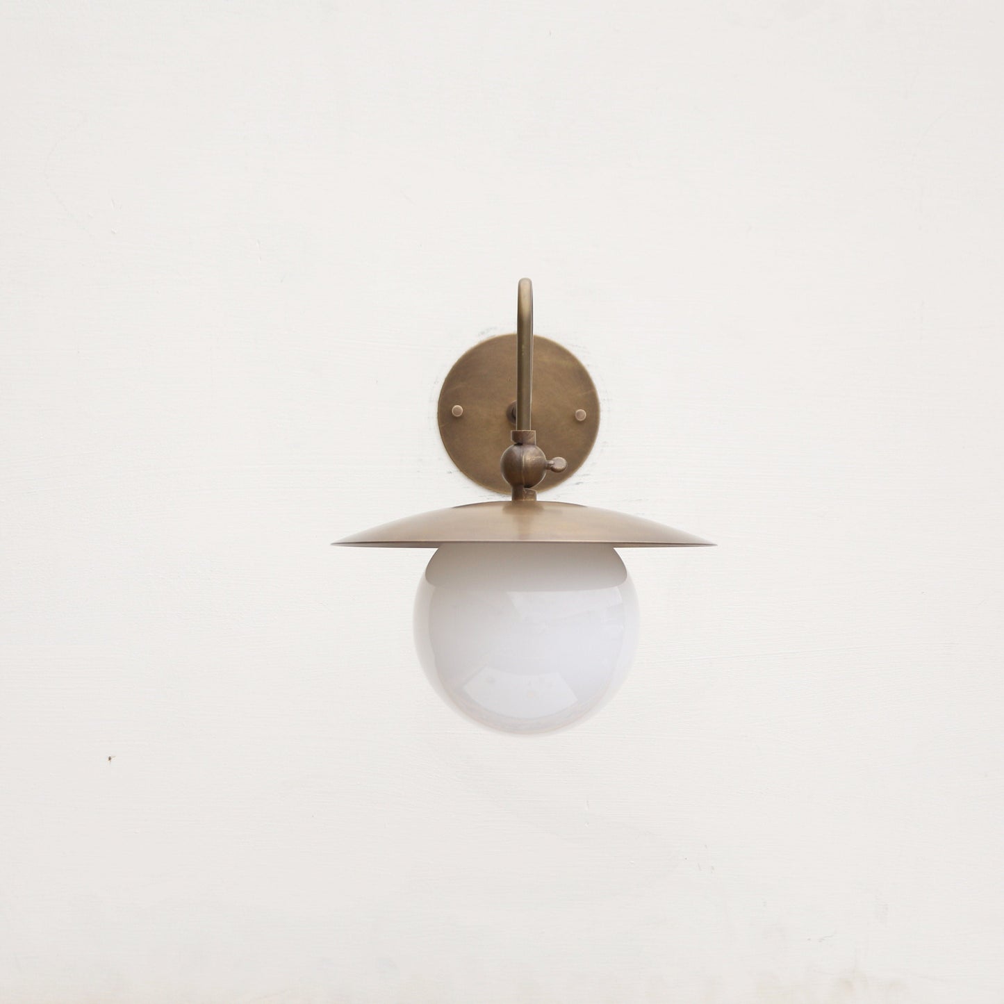 One-Light Brass Dish Wall Sconce with Curved Arm and Milk Glass Shade