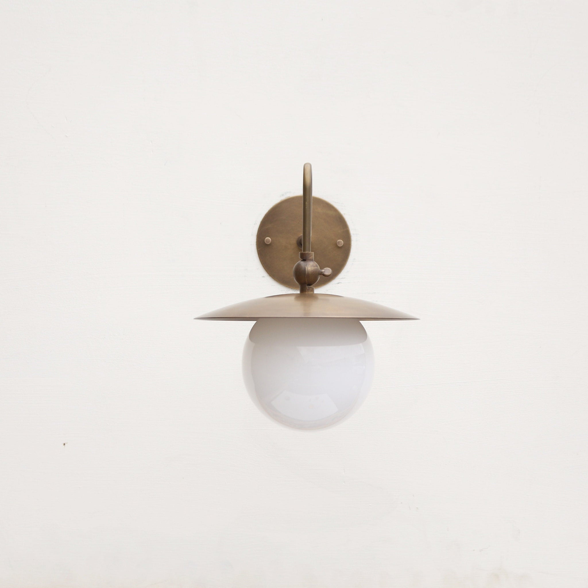 One-Light Brass Dish Wall Sconce with Curved Arm and Milk Glass Shade