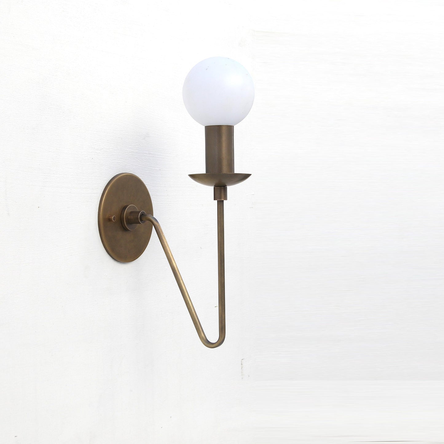 One-Light Brass Sconce with Curved Arm and Opal Glass Globe