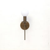 One-Light Brass Sconce with Curved Arm and Opal Glass Globe