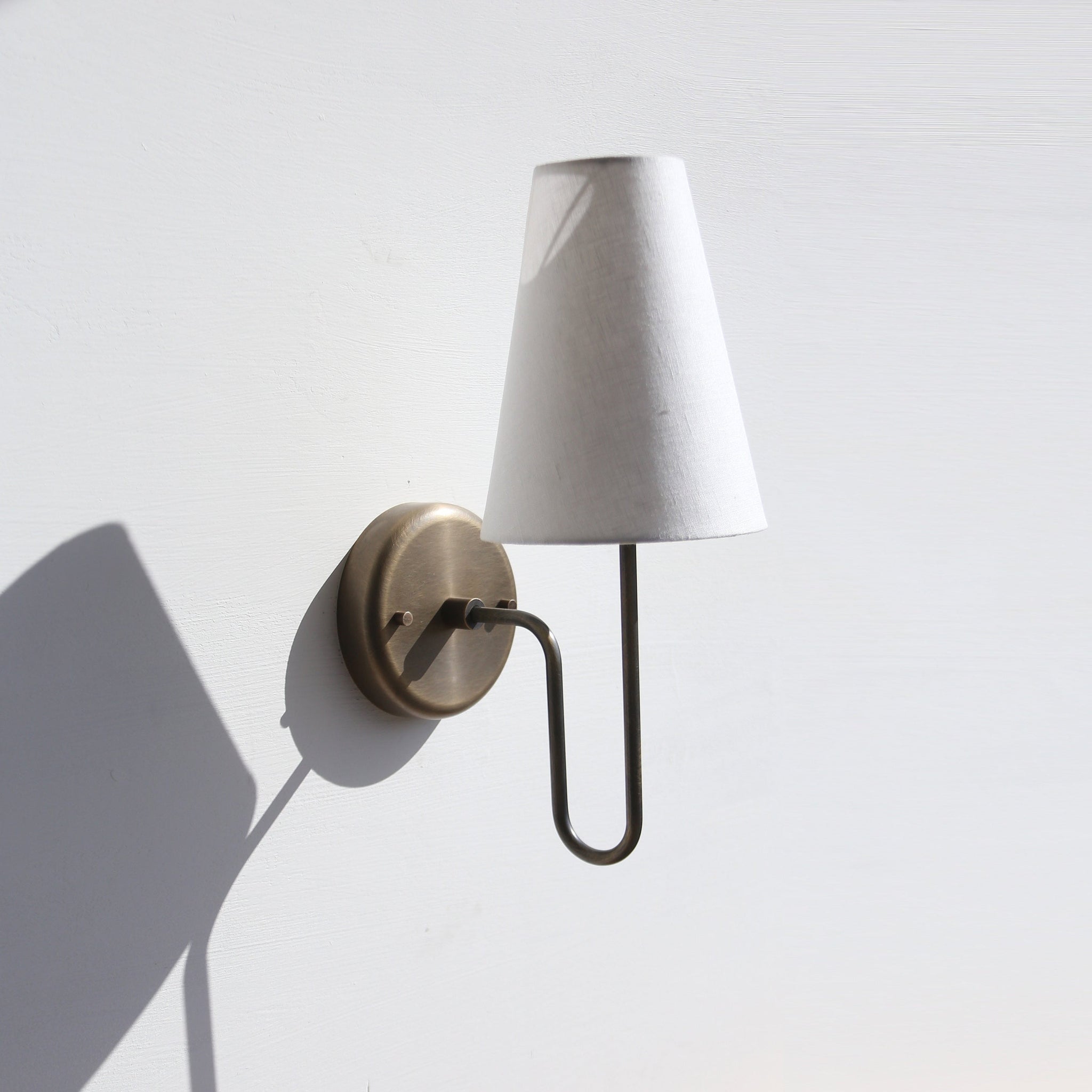 One-Light Linen Shade Wall Sconce with Curved Brass Arm