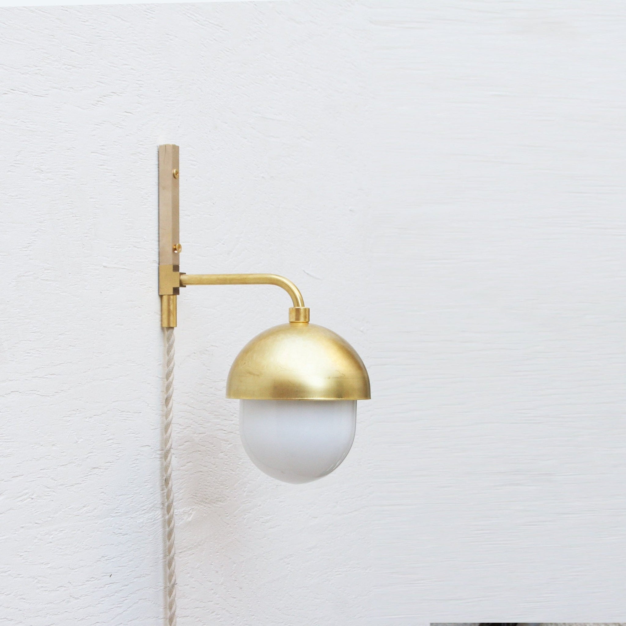 One-Light Plug-In Wall Sconce with Brass Cap and Opal Globe