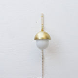 One-Light Plug-In Wall Sconce with Brass Cap and Opal Globe