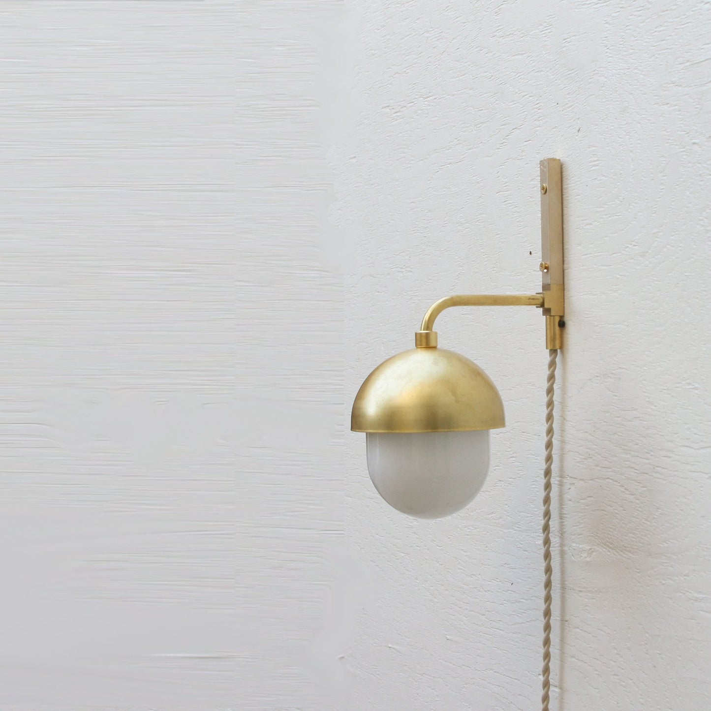 One-Light Plug-In Wall Sconce with Brass Cap and Opal Globe