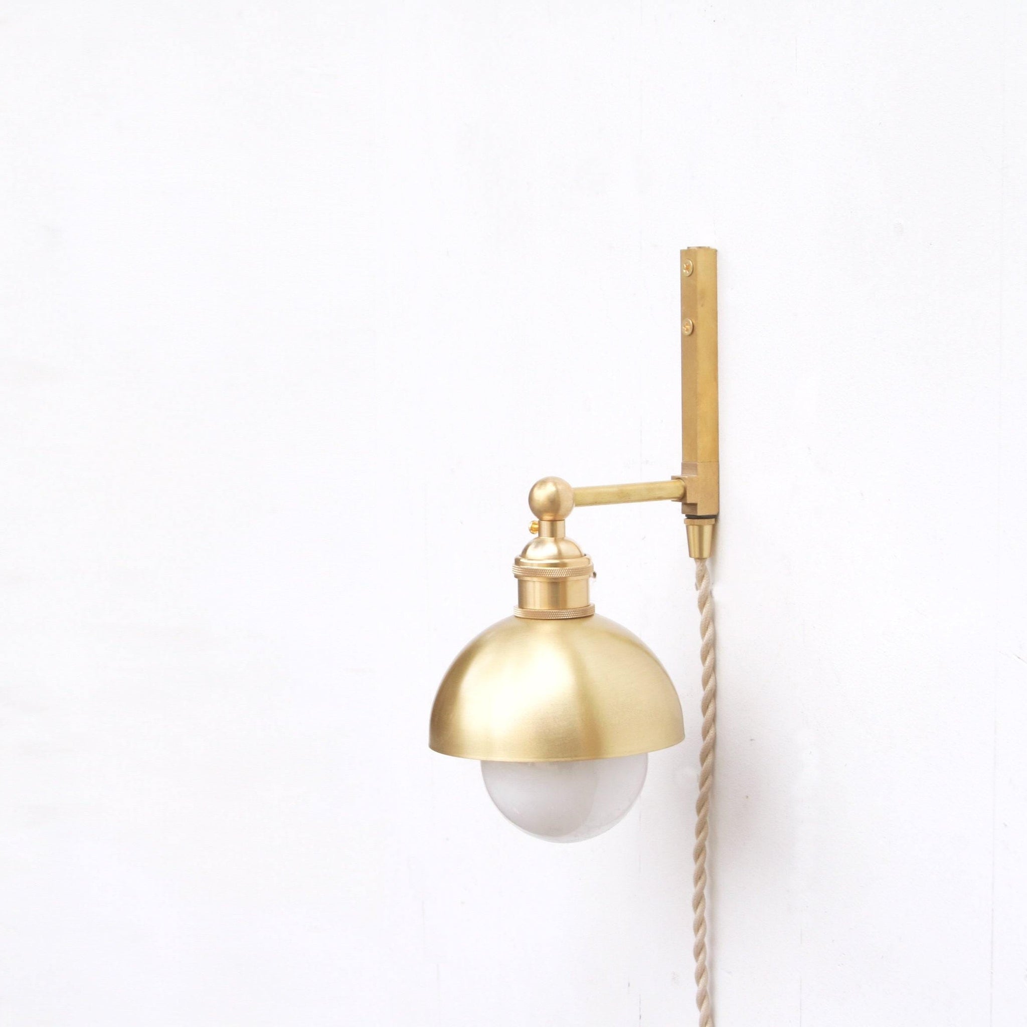 One-Light Plug-In Wall Sconce with Brass Dome Shade