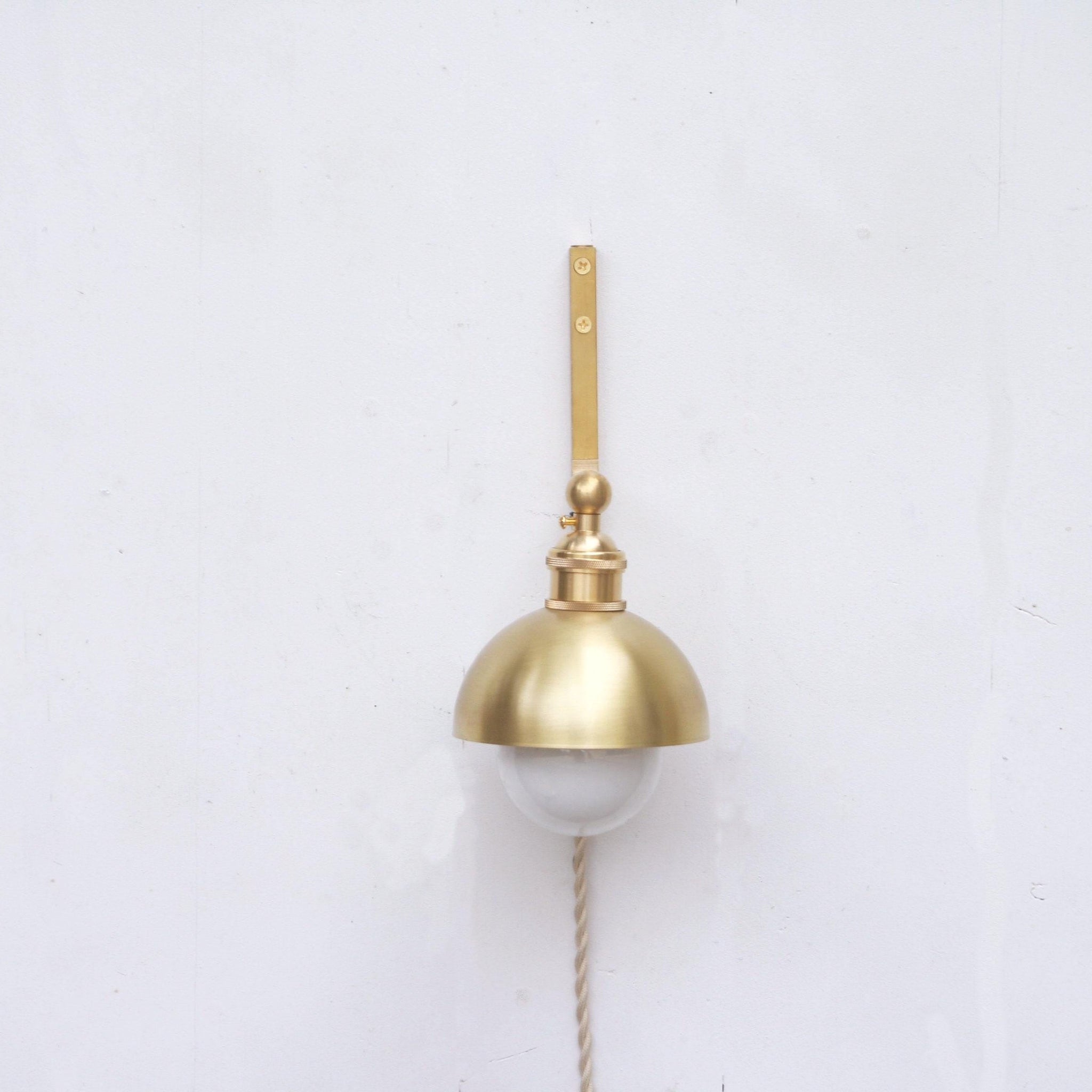 One-Light Plug-In Wall Sconce with Brass Dome Shade