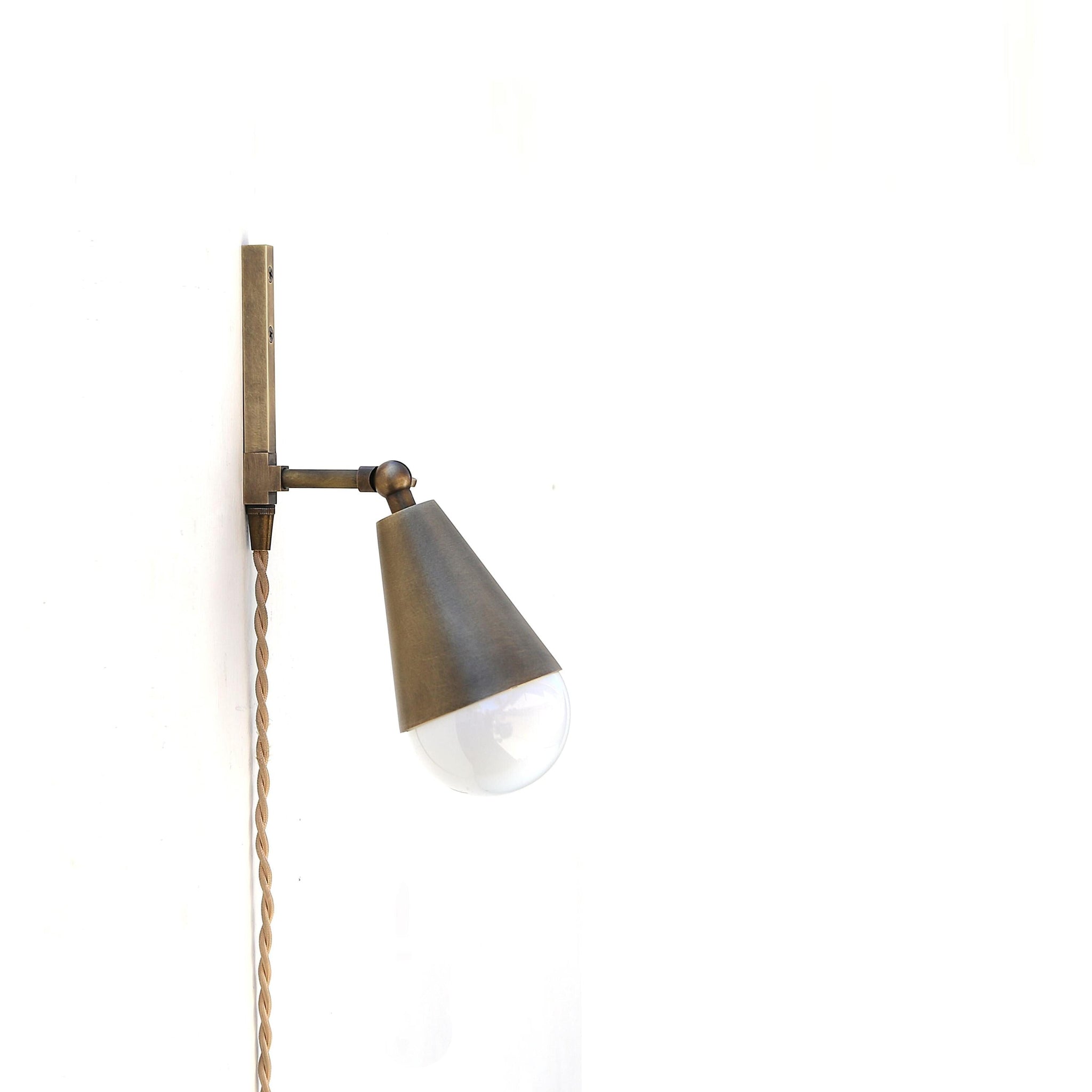 One-Light Plug-In Wall Sconce with Pivoting Brass Cone Shade