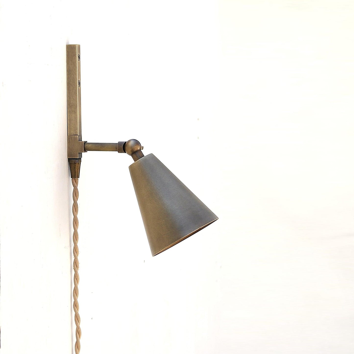 One-Light Plug-In Wall Sconce with Pivoting Brass Cone Shade