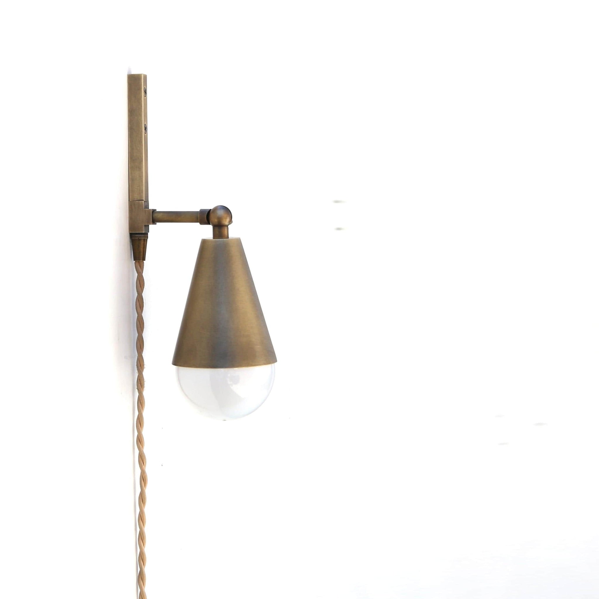 One-Light Plug-In Wall Sconce with Pivoting Brass Cone Shade