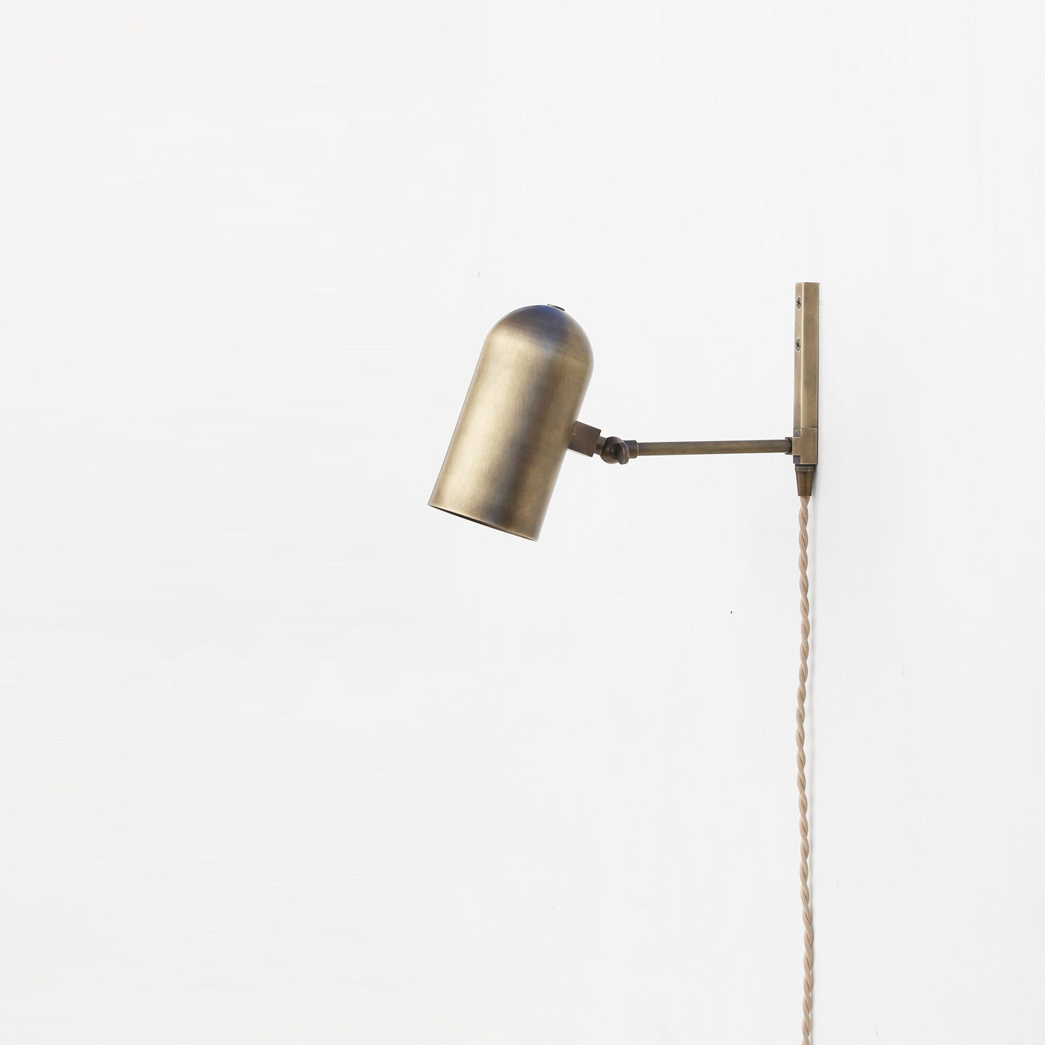 One-Light Plug-In Wall Sconce with Pivoting Brass Cylinder