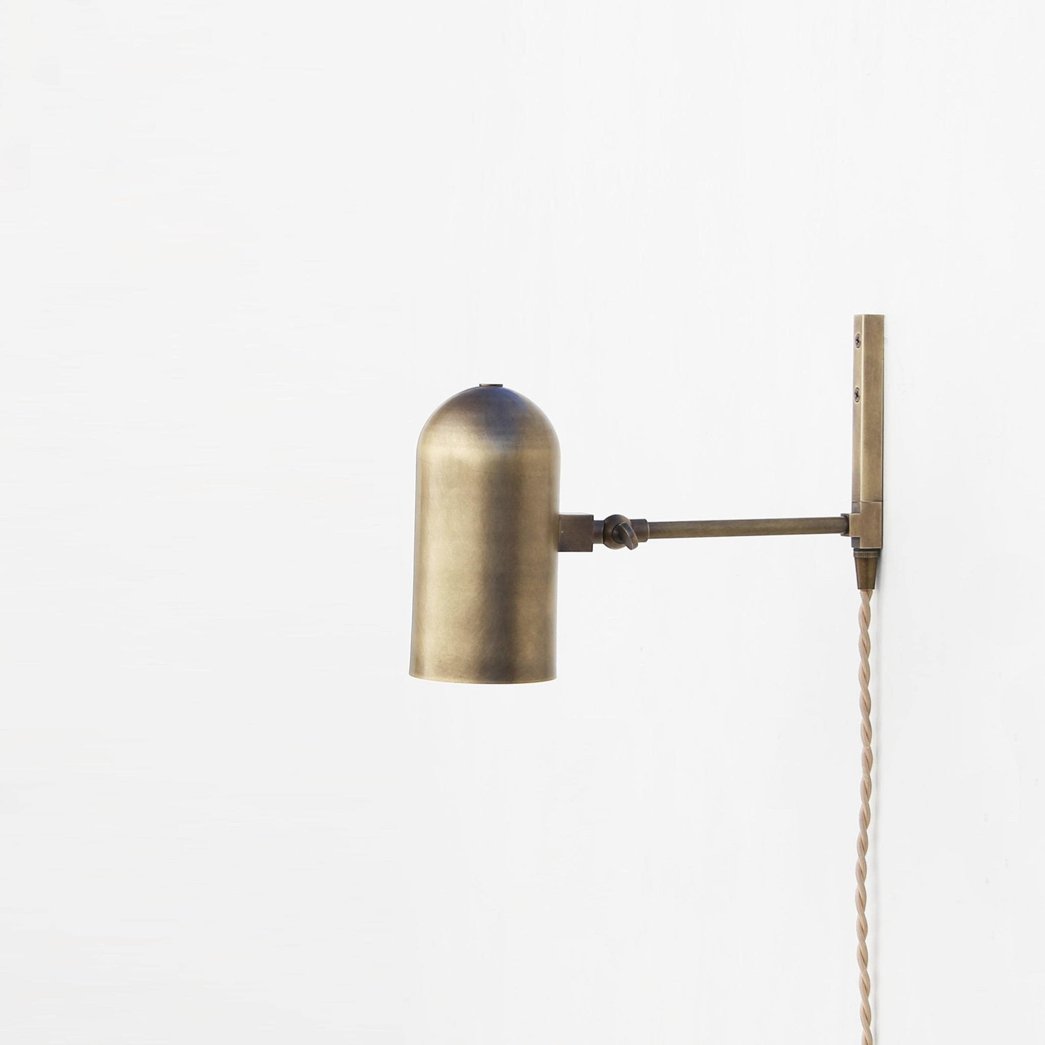 One-Light Plug-In Wall Sconce with Pivoting Brass Cylinder