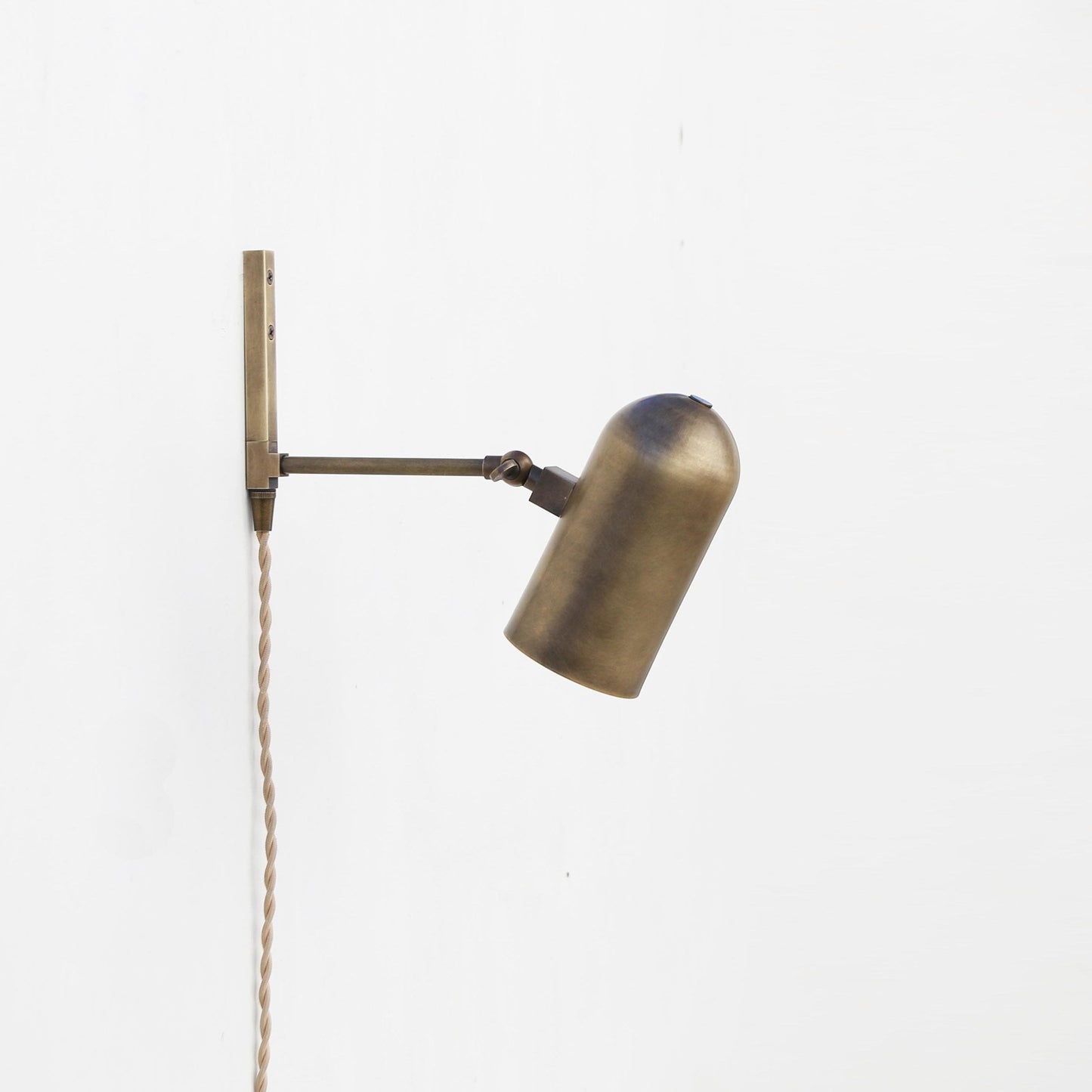 One-Light Plug-In Wall Sconce with Pivoting Brass Cylinder