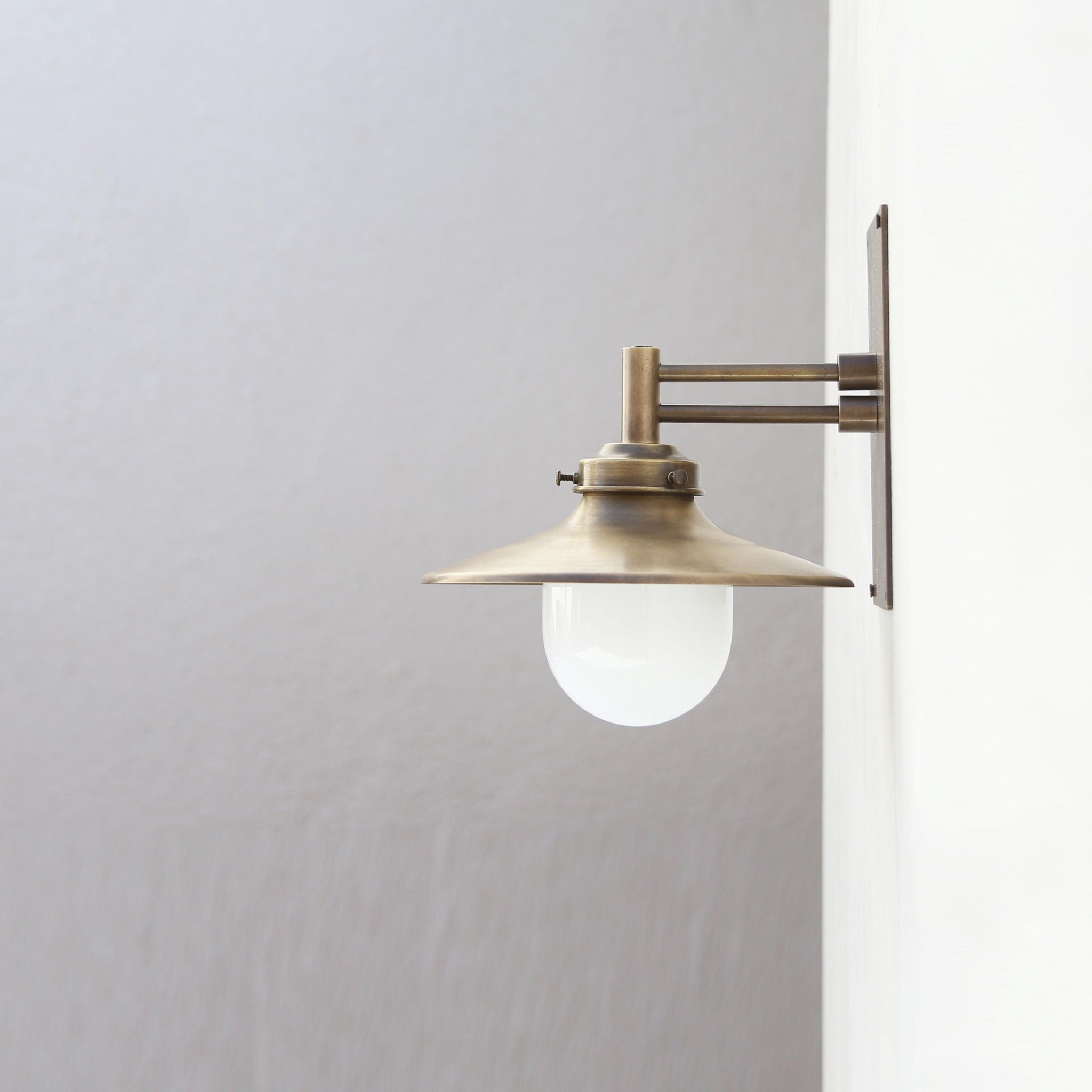 One-Light Swing-Arm Wall Sconce with Brass Coolie Shade