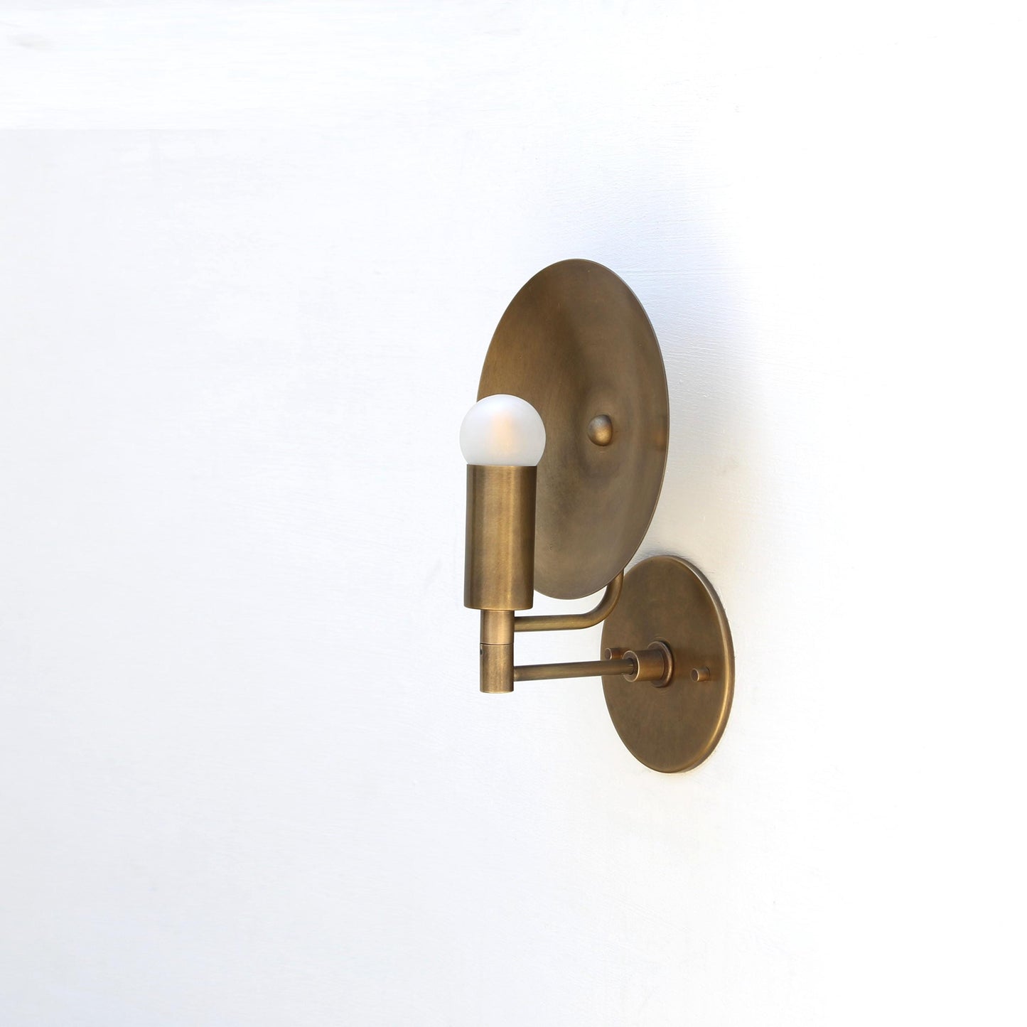 One-Light Wall Sconce with Round Brass Reflector Disc