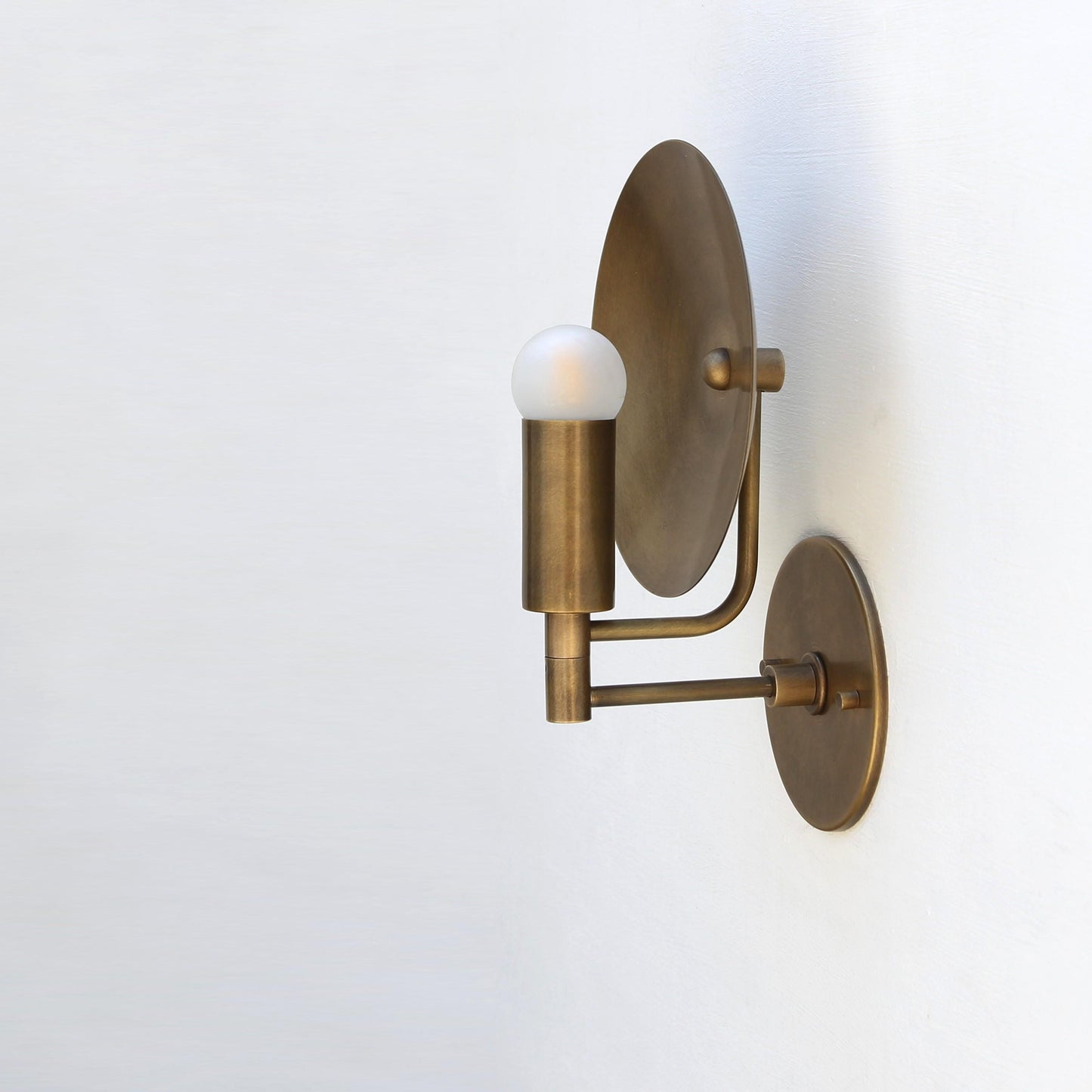 One-Light Wall Sconce with Round Brass Reflector Disc