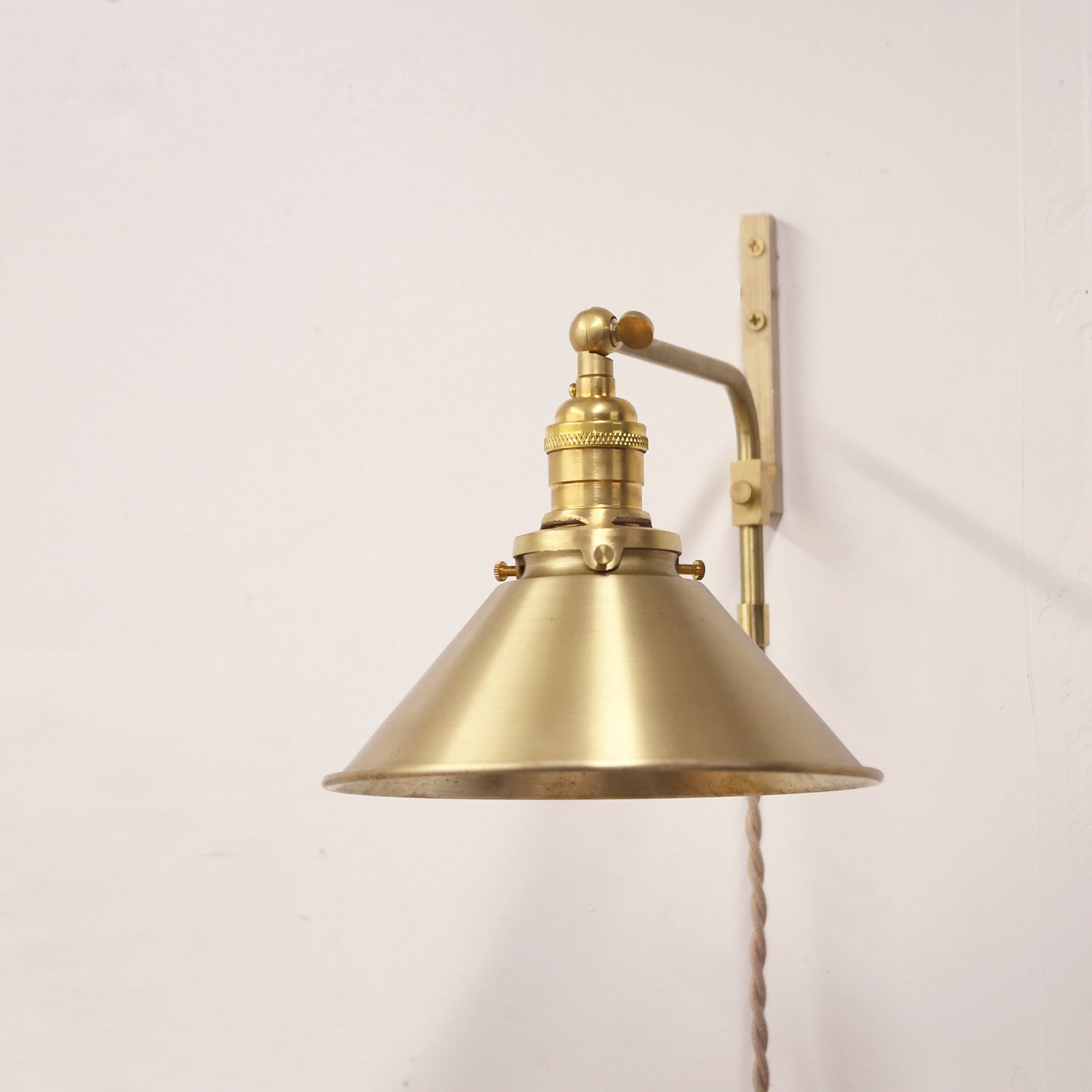 Plug-In Swing Arm Wall Sconce with Brass Cone Shade