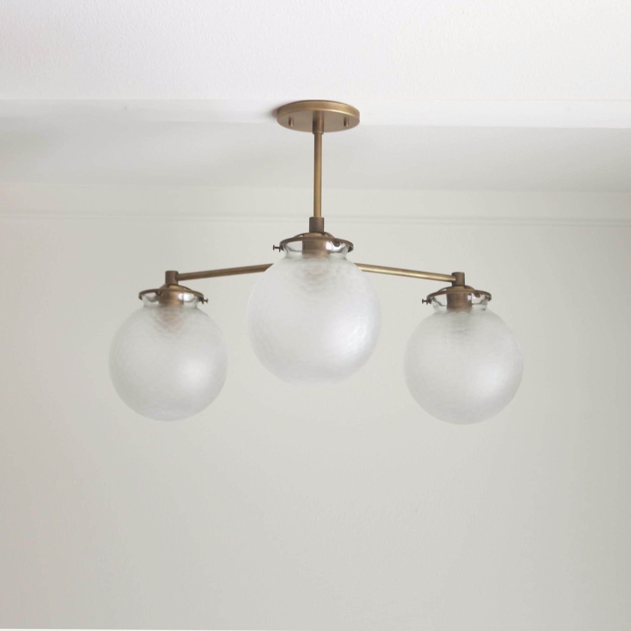 Three-Light Brass Chandelier with Frosted Globes