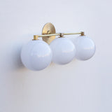 Three-Light Brass Vanity Sconce with Six-Inch Opal Globes
