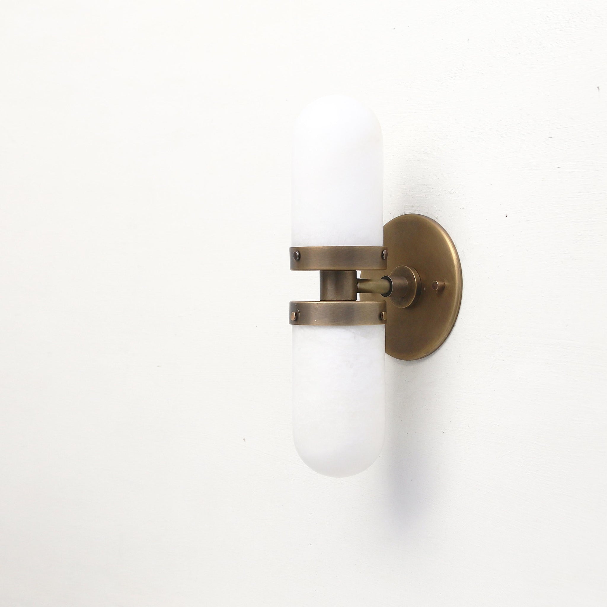 Two-Light Brass Wall Sconce with Clamped Alabaster Capsules