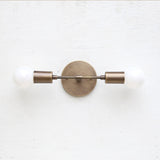 Two-Light Brass Wall Sconce with Exposed Bulbs