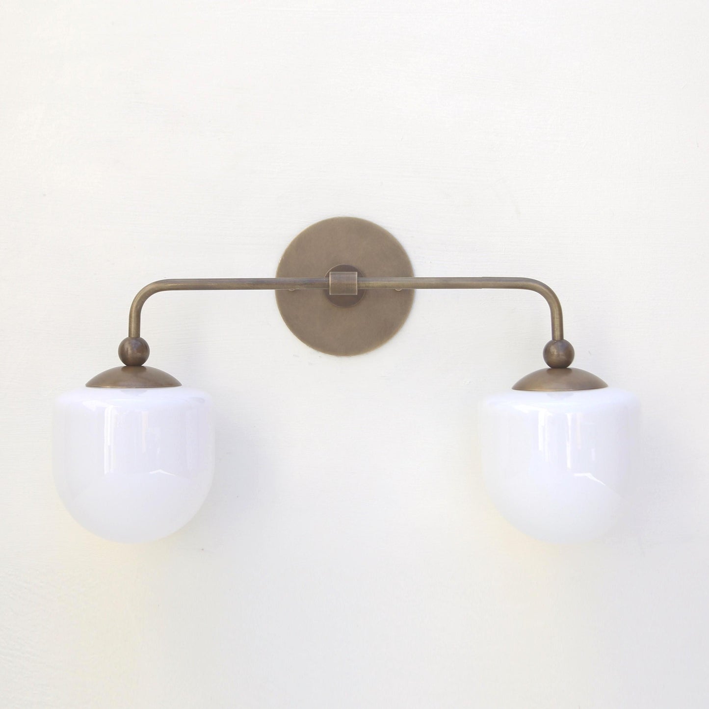 Two-Light Brass Wall Sconce with Opal Glass Globe Shades