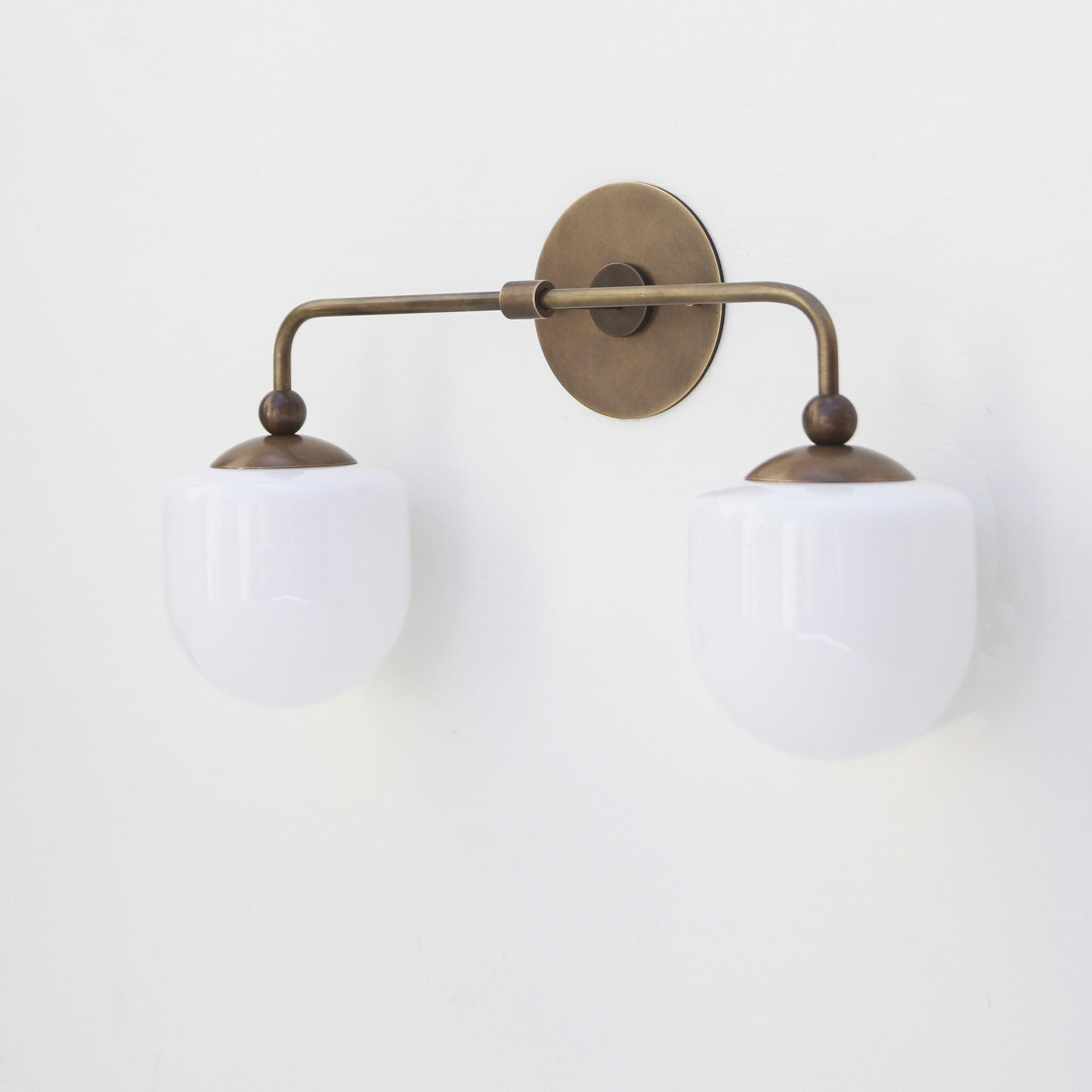Two-Light Brass Wall Sconce with Opal Glass Globe Shades