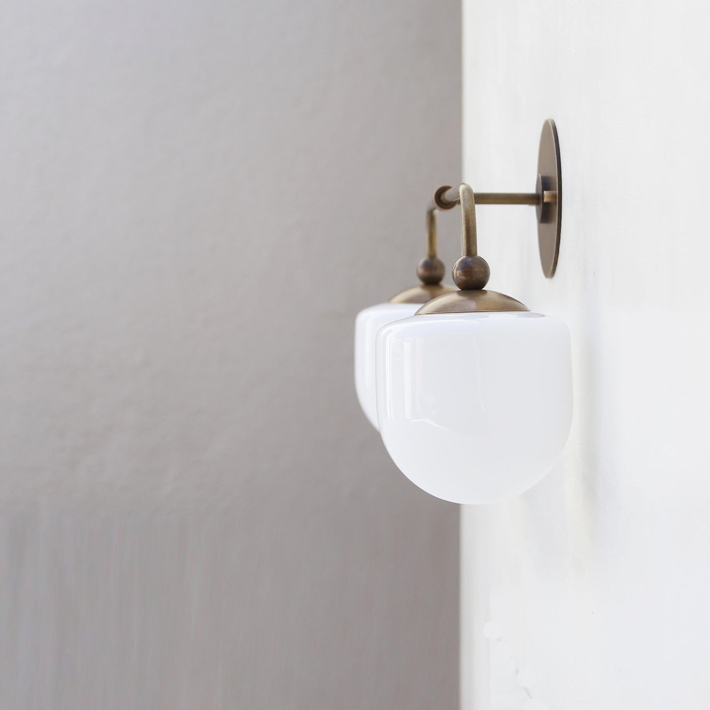 Two-Light Brass Wall Sconce with Opal Glass Globe Shades