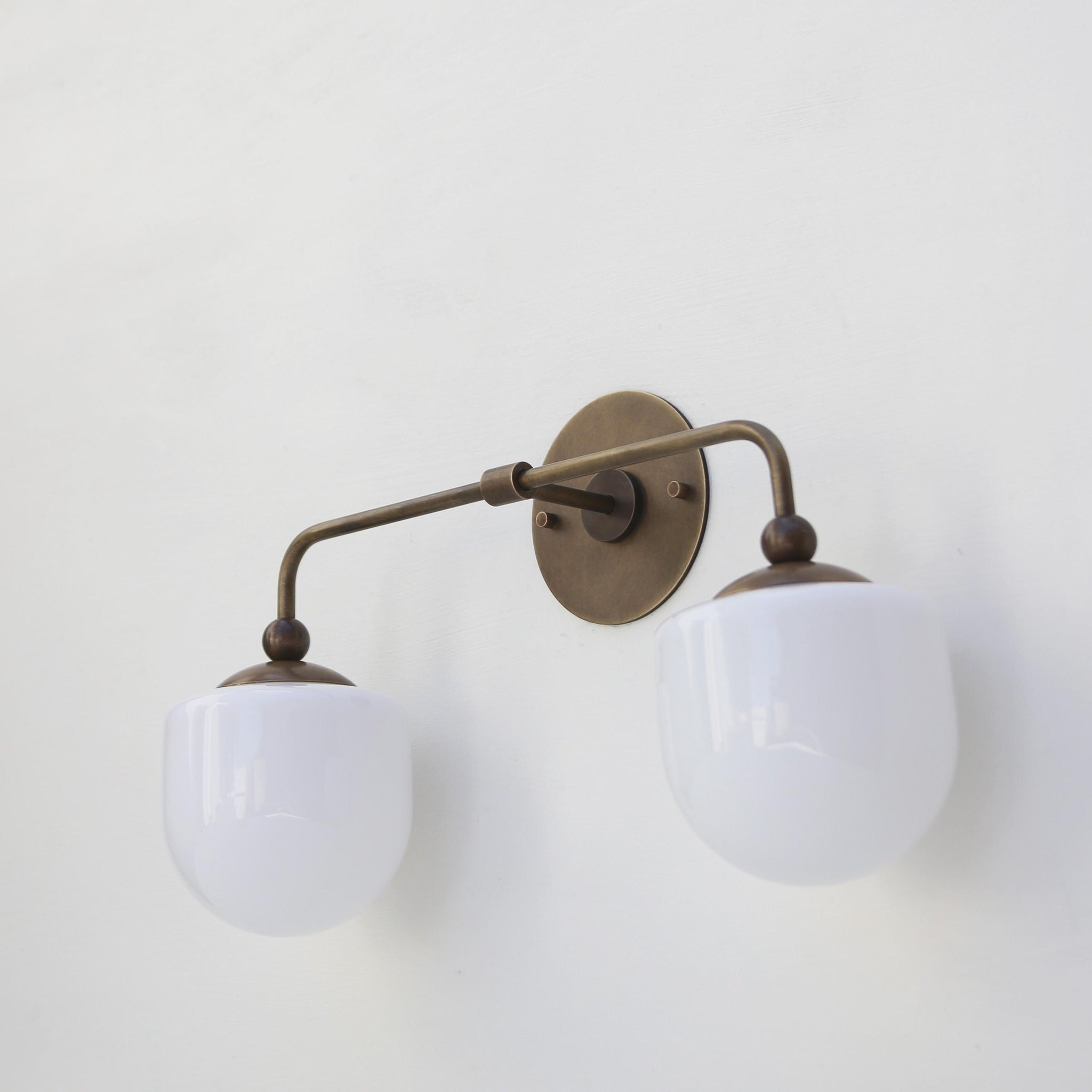 Two-Light Brass Wall Sconce with Opal Glass Globe Shades