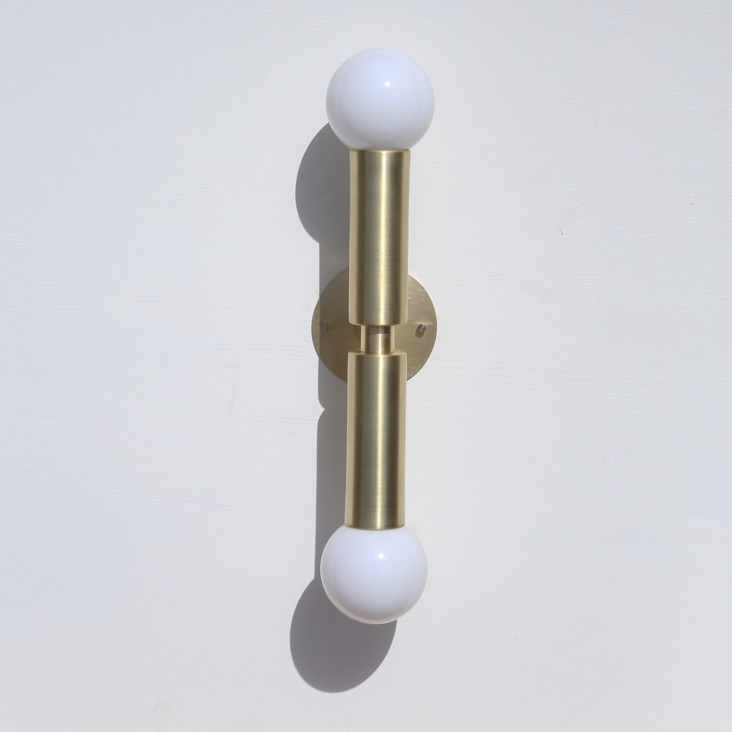 Two-Light Opal Globe Wall Sconce with Vertical Brass Arms