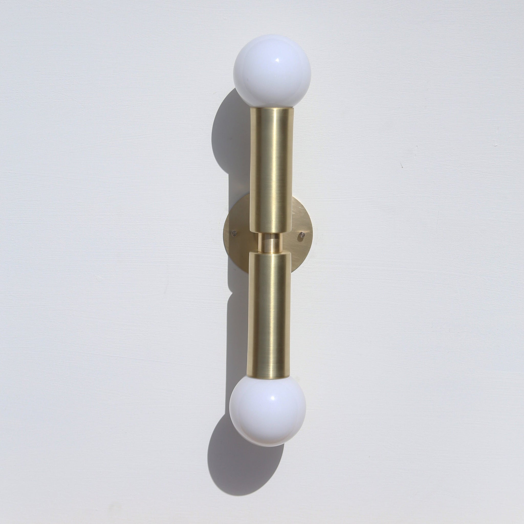 Two-Light Opal Globe Wall Sconce with Vertical Brass Arms